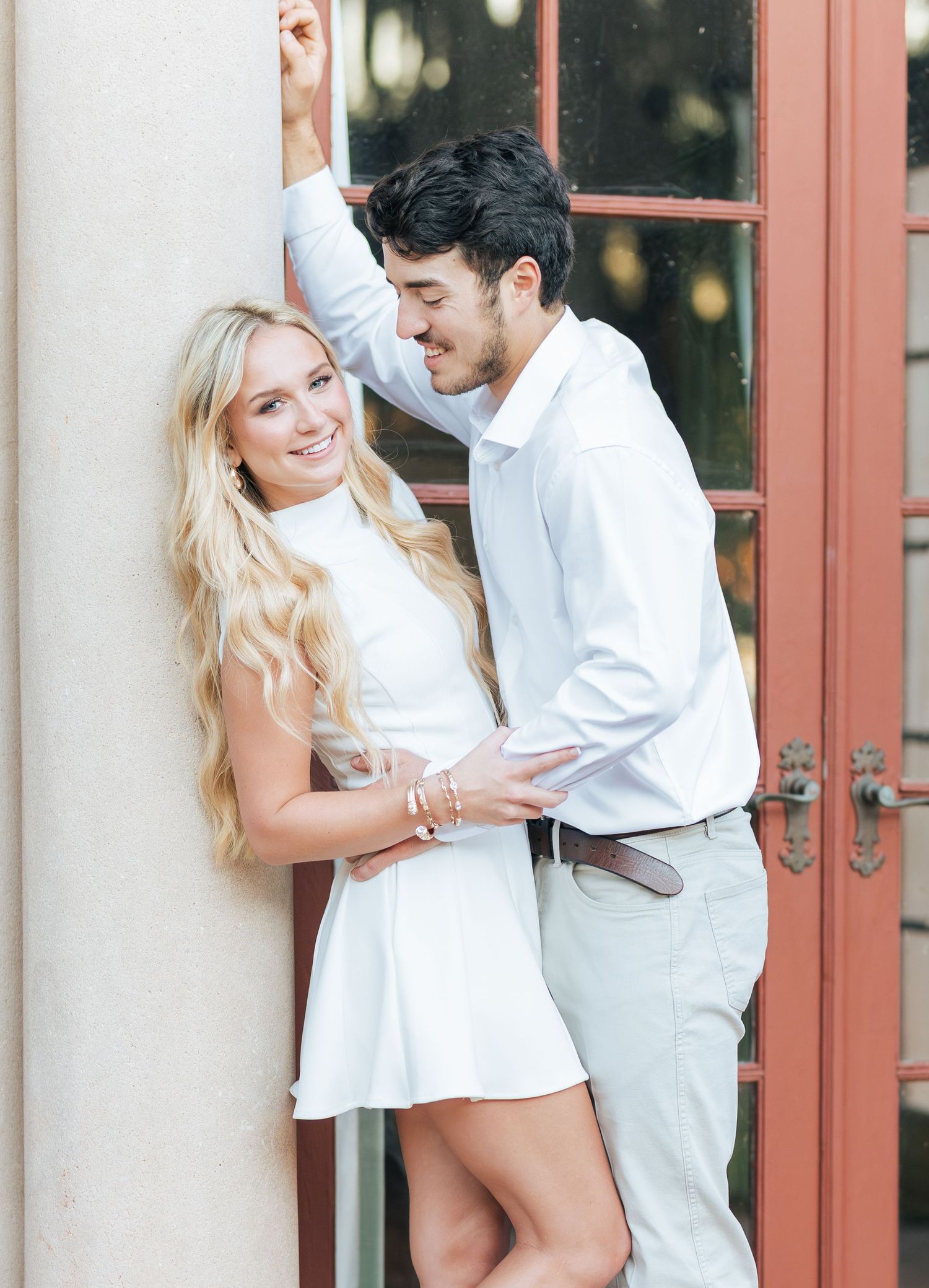 A romantic engagement session featuring tender moments against a classic architectural backdrop.