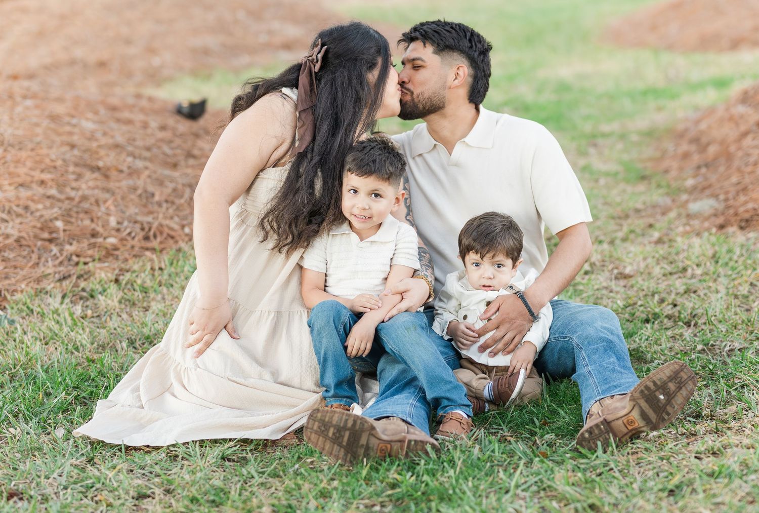 Candid family moments photographed in a natural outdoor setting with trees in background.