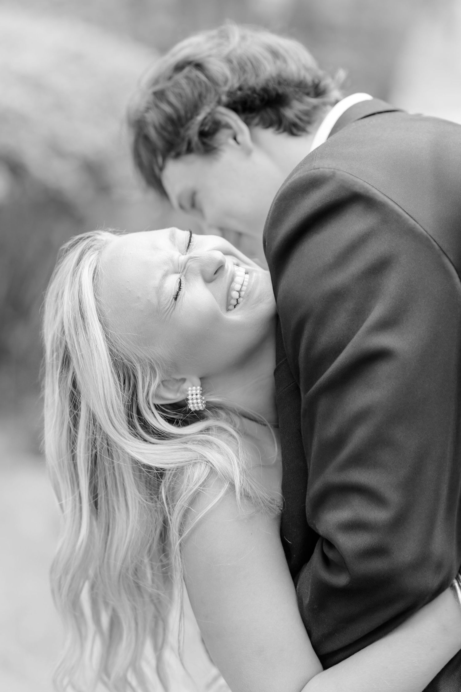 Black and white romantic photo series of a couple sharing intimate moments together.