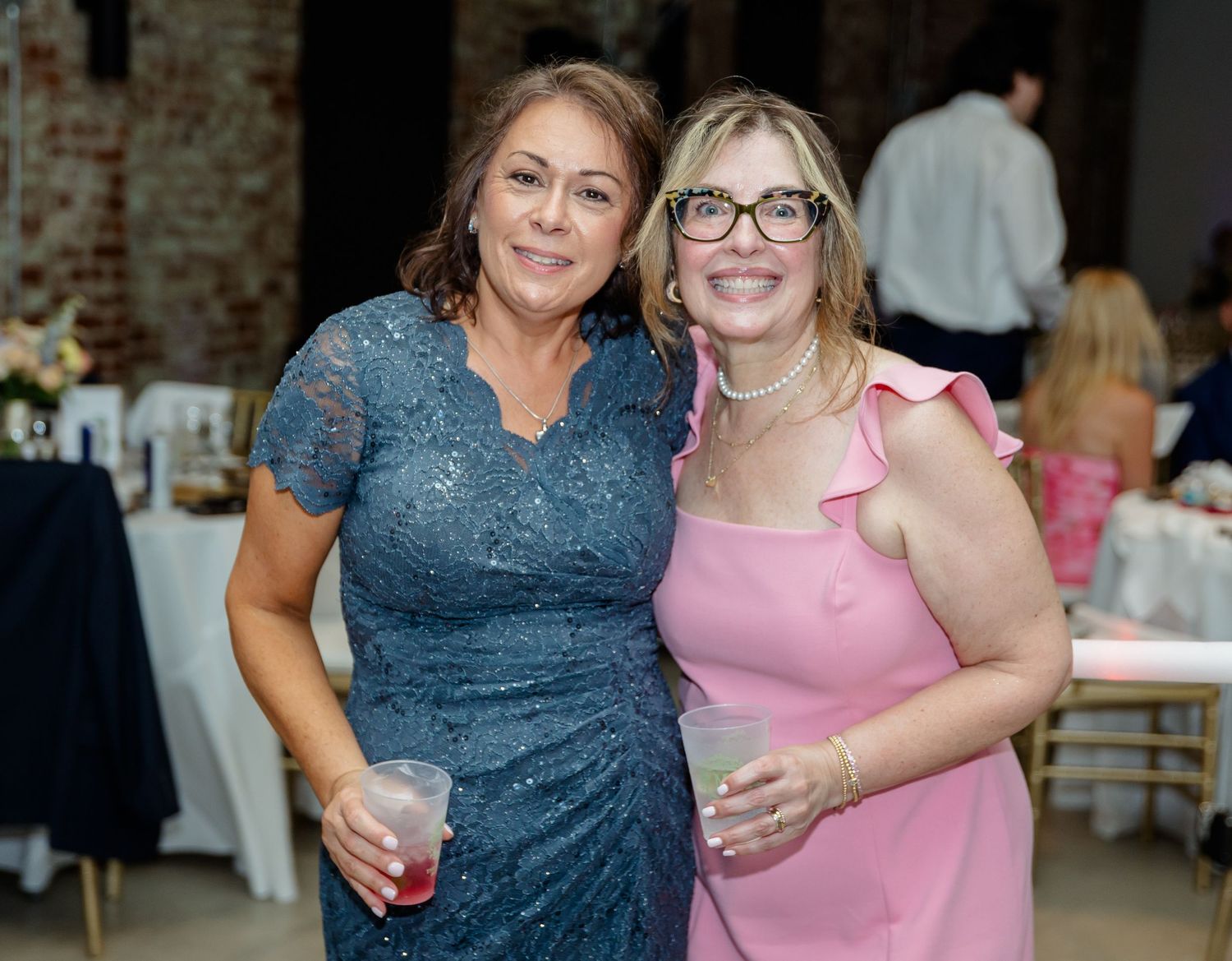 Wedding guests enjoying themselves at an indoor reception venue.