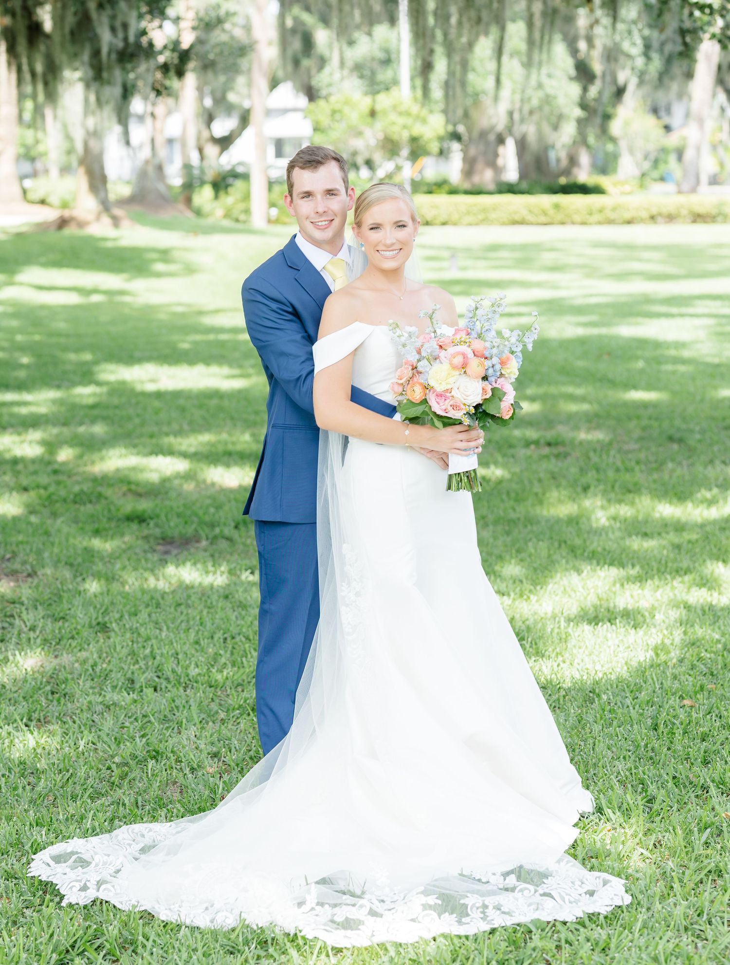 Bride and groom share intimate moments during their first look photo session in a lush outdoor garden setting.