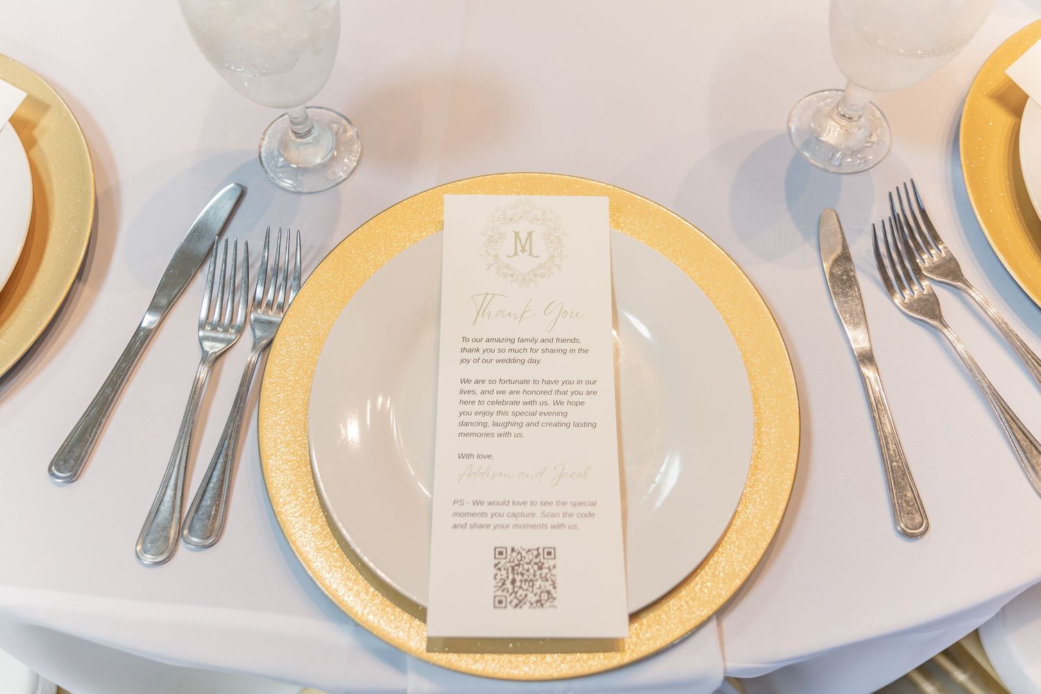 Elegant place settings with gold charger plates and white linens arranged on a formal dining table.