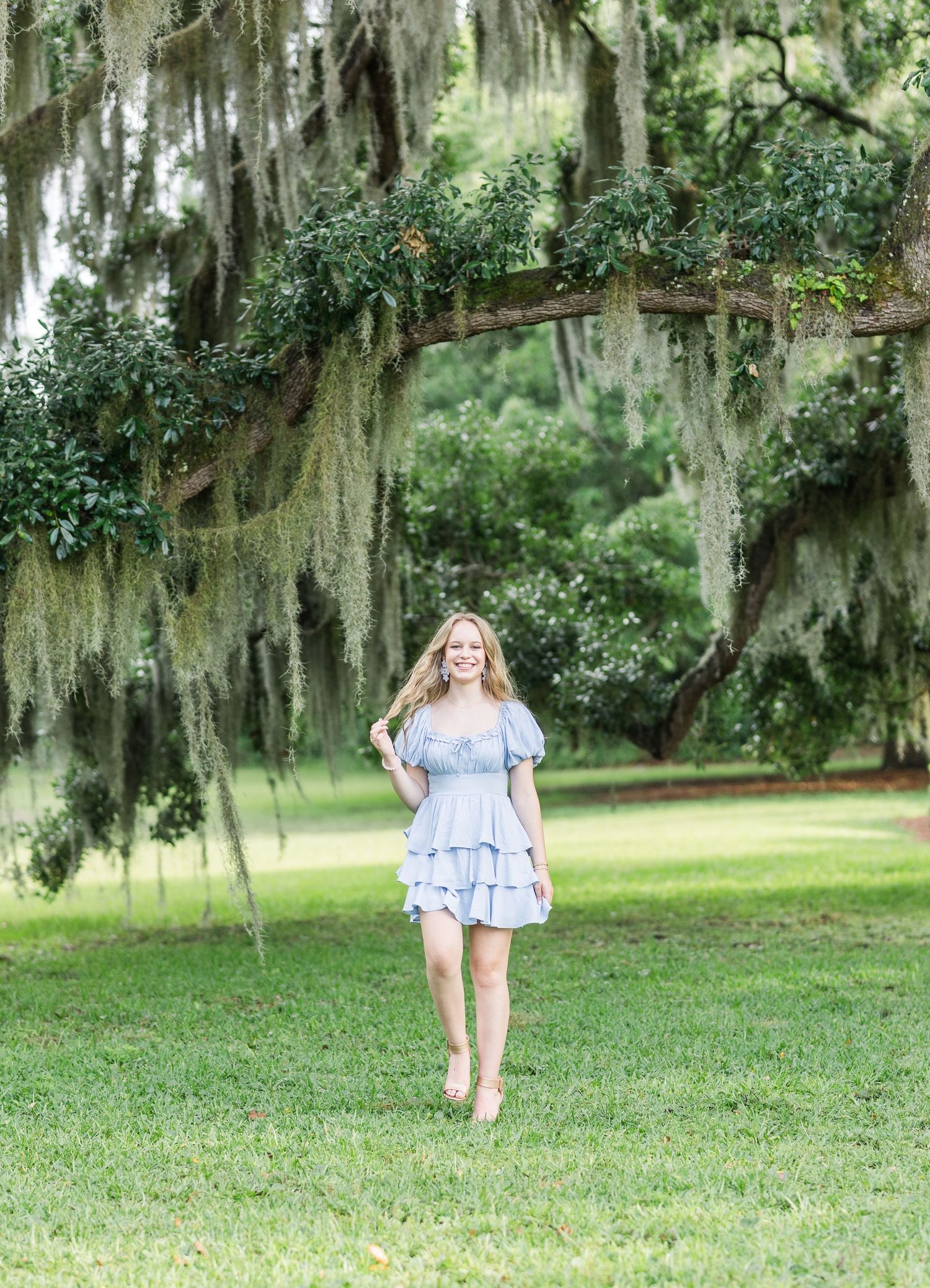 Light and airy outdoor portraits captured in a lush Southern garden with Spanish moss draped oak trees.