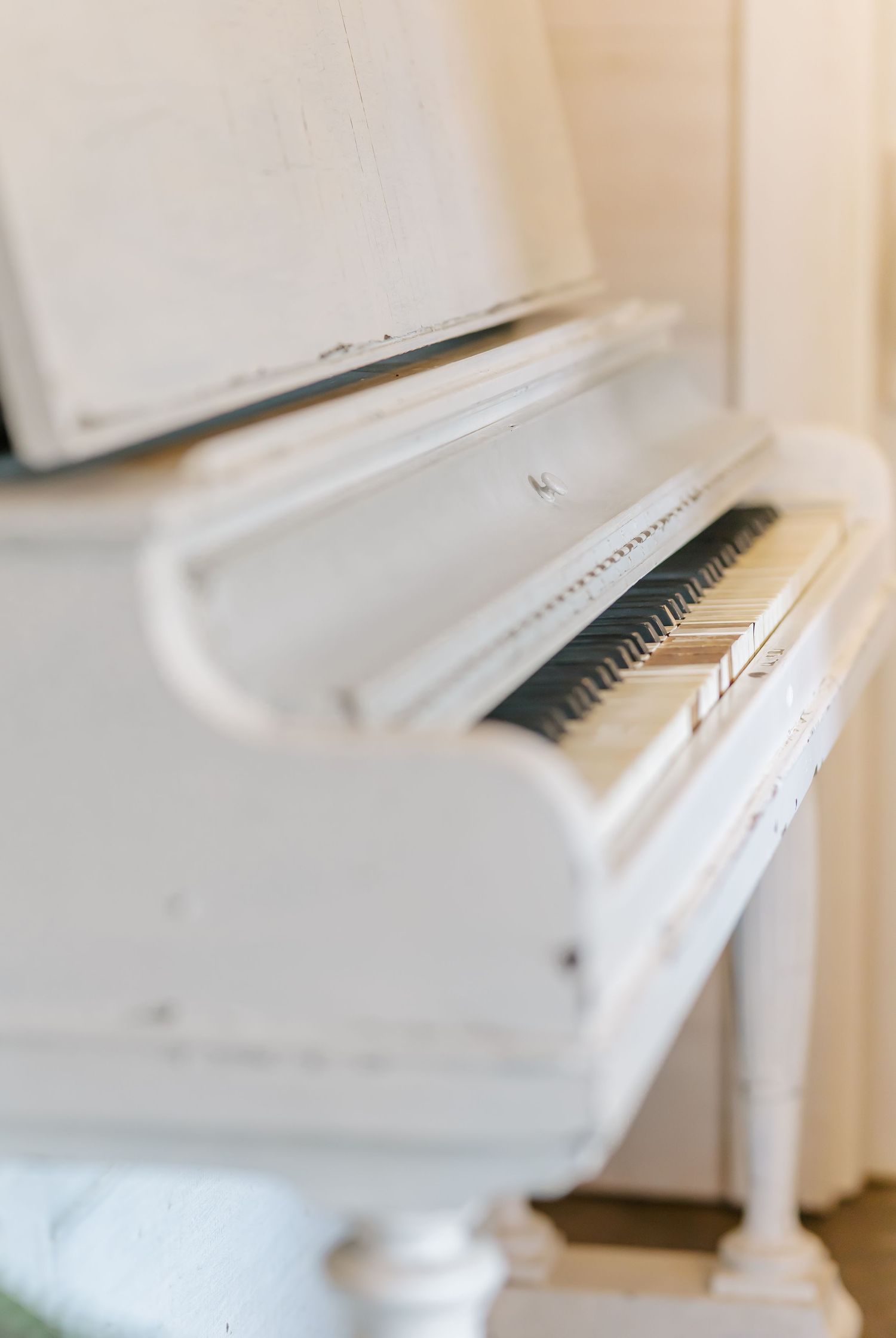 Multiple artistic views of a white piano in a bright minimalist room setting.