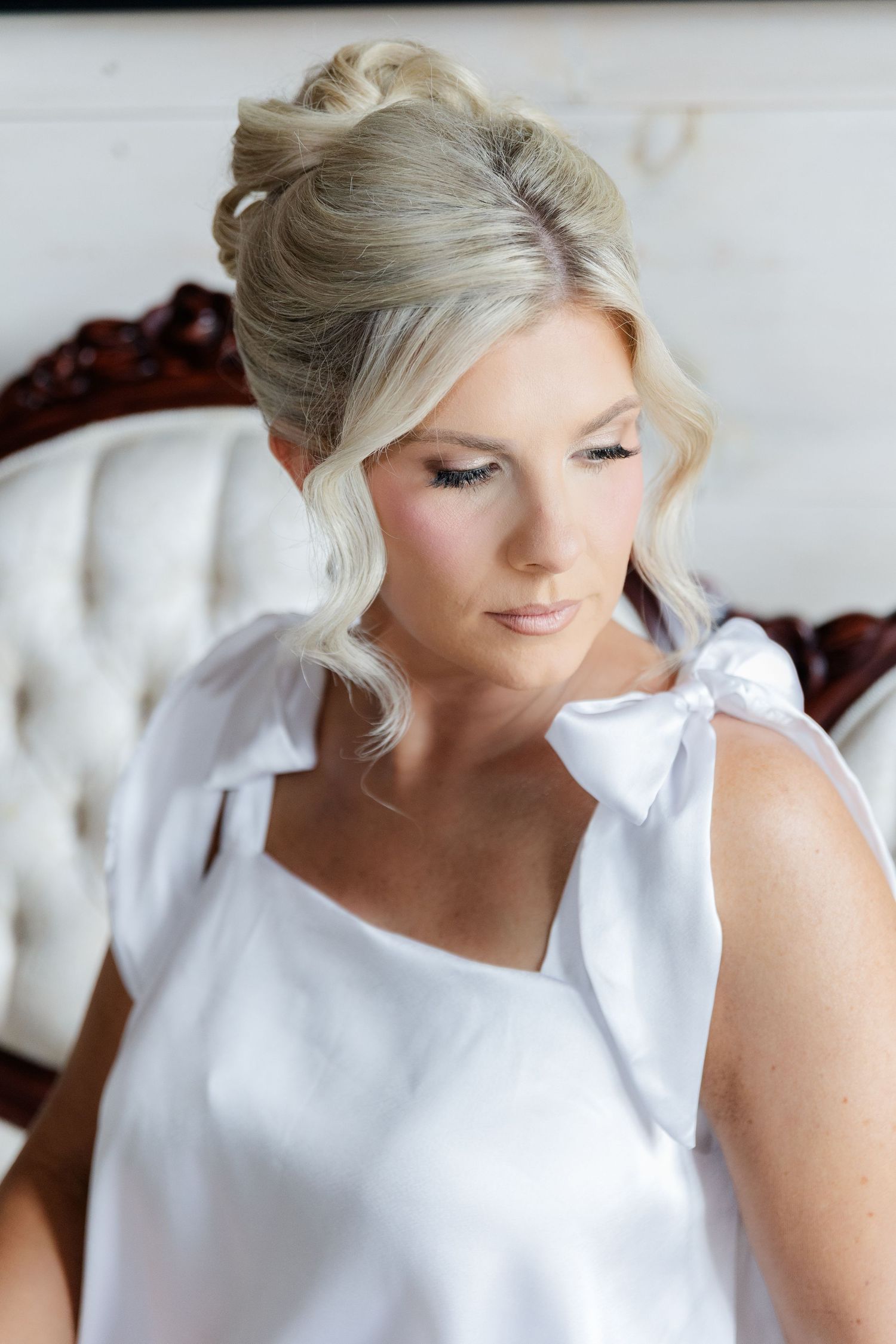 A sequence of close-up shots showing a bride's elegant updo hairstyle with blonde hair from different angles.