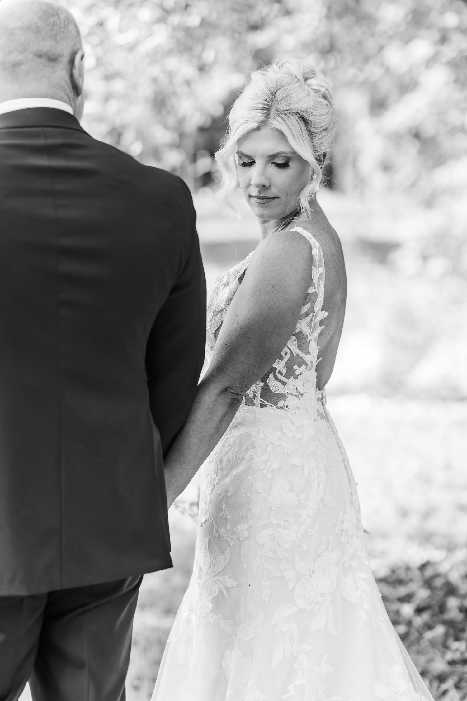 Black and white wedding photo collage showing romantic moments between couple in elegant dress and suit outdoors.