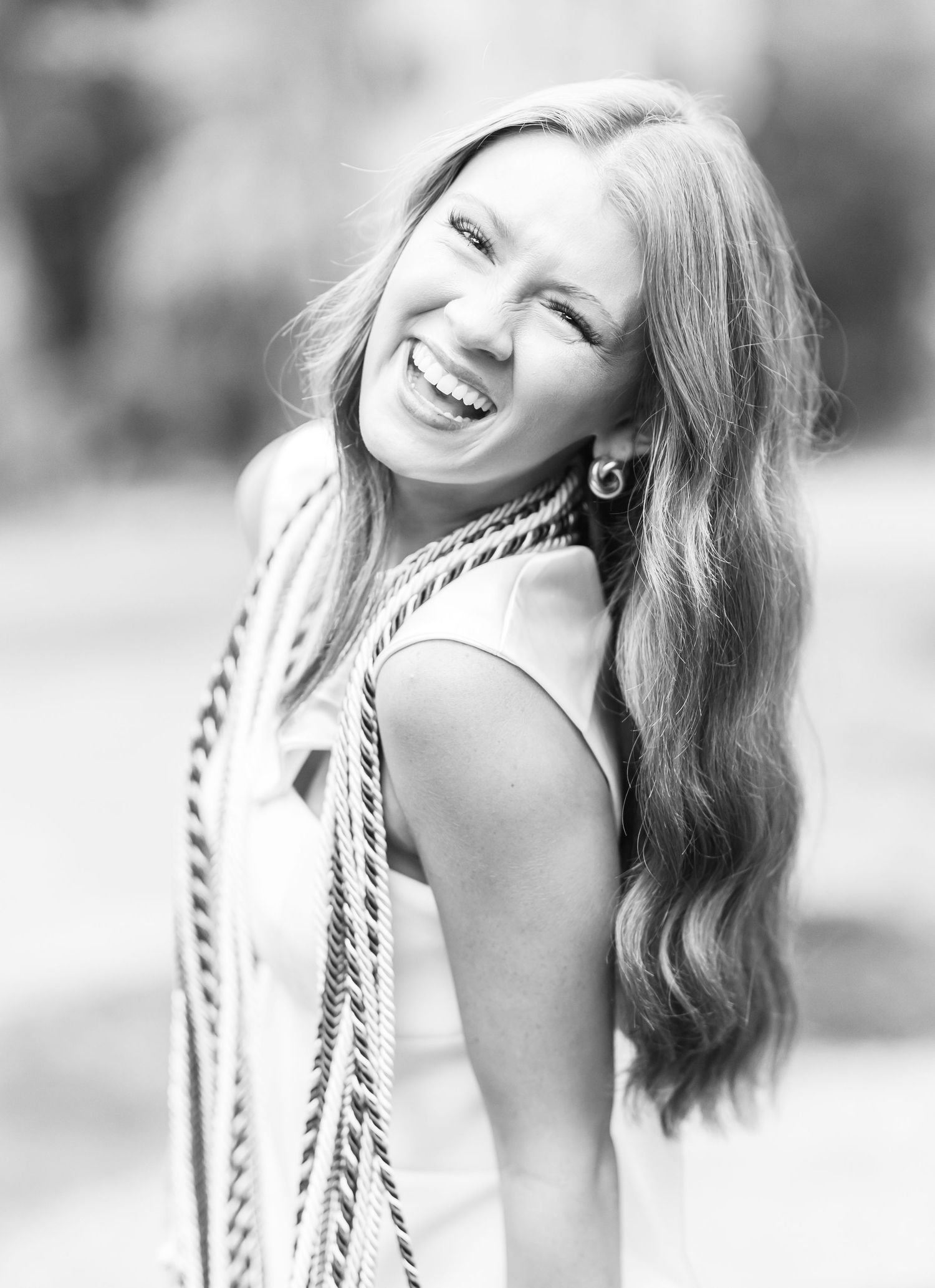 A black and white series of profile portraits showing joyful expressions and flowing hair.