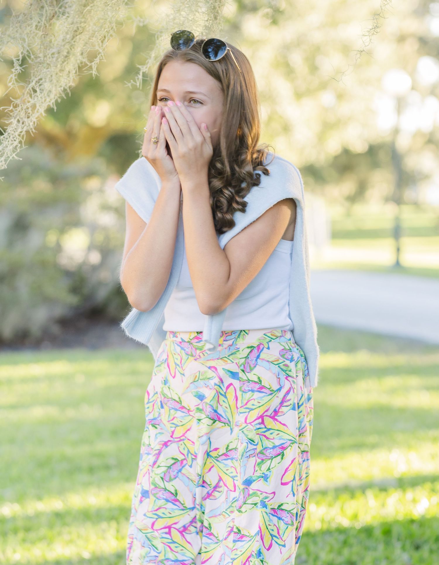 A joyful reaction captured in a sunny garden setting.