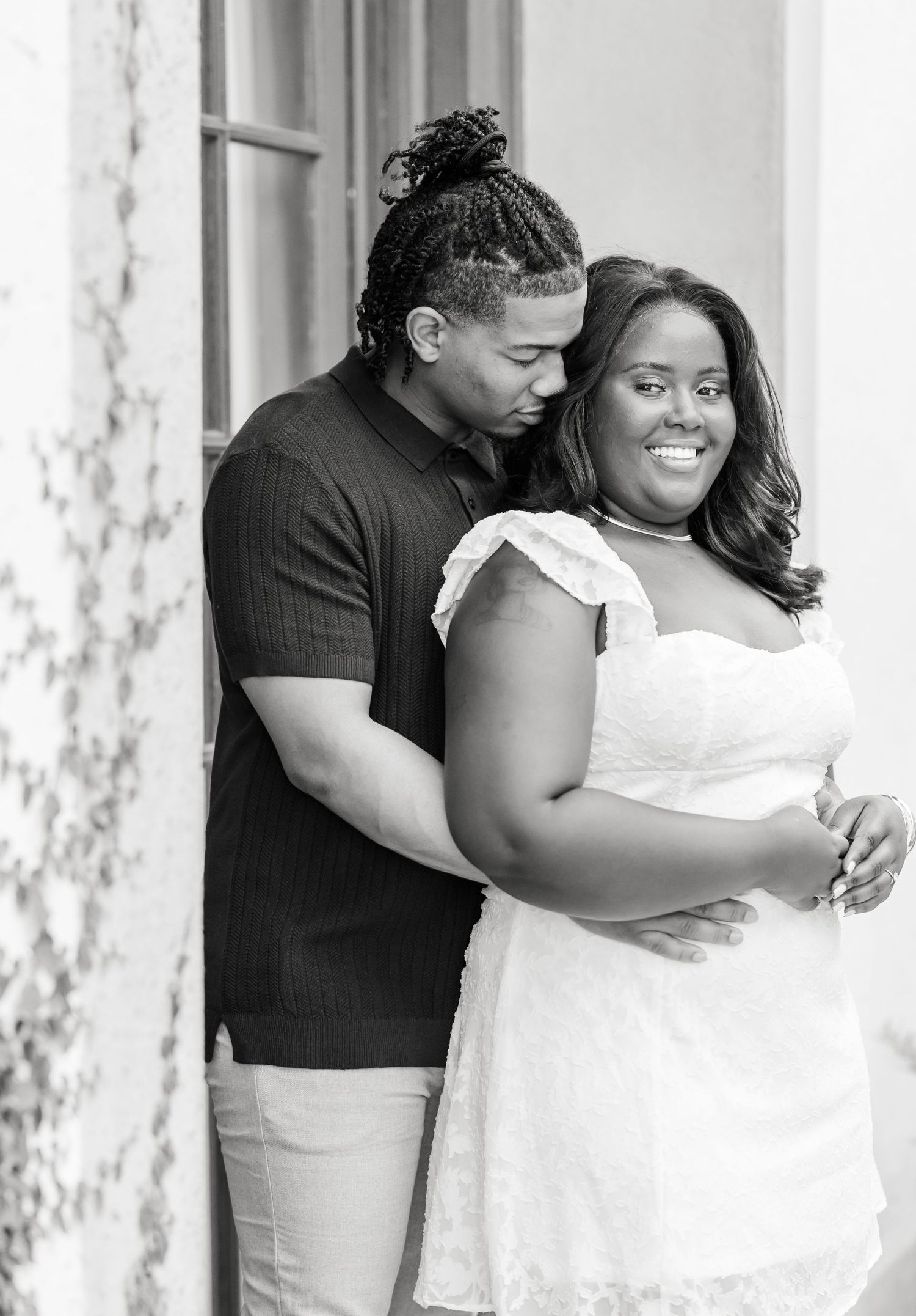 Black and white portraits showing intimate moments between a couple against a white backdrop.