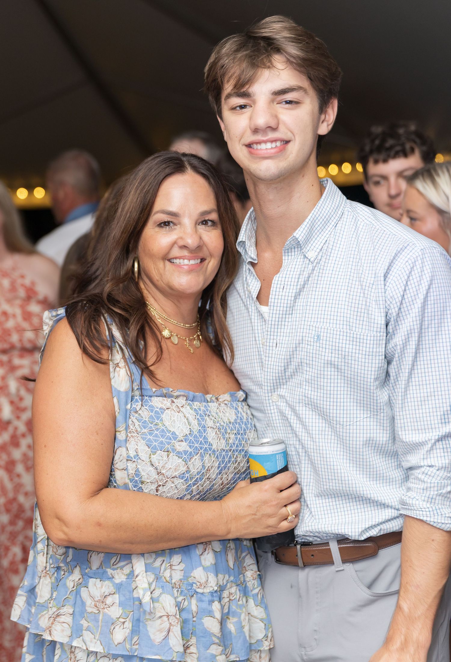 Guests sharing warm embraces and smiles during a celebratory event.