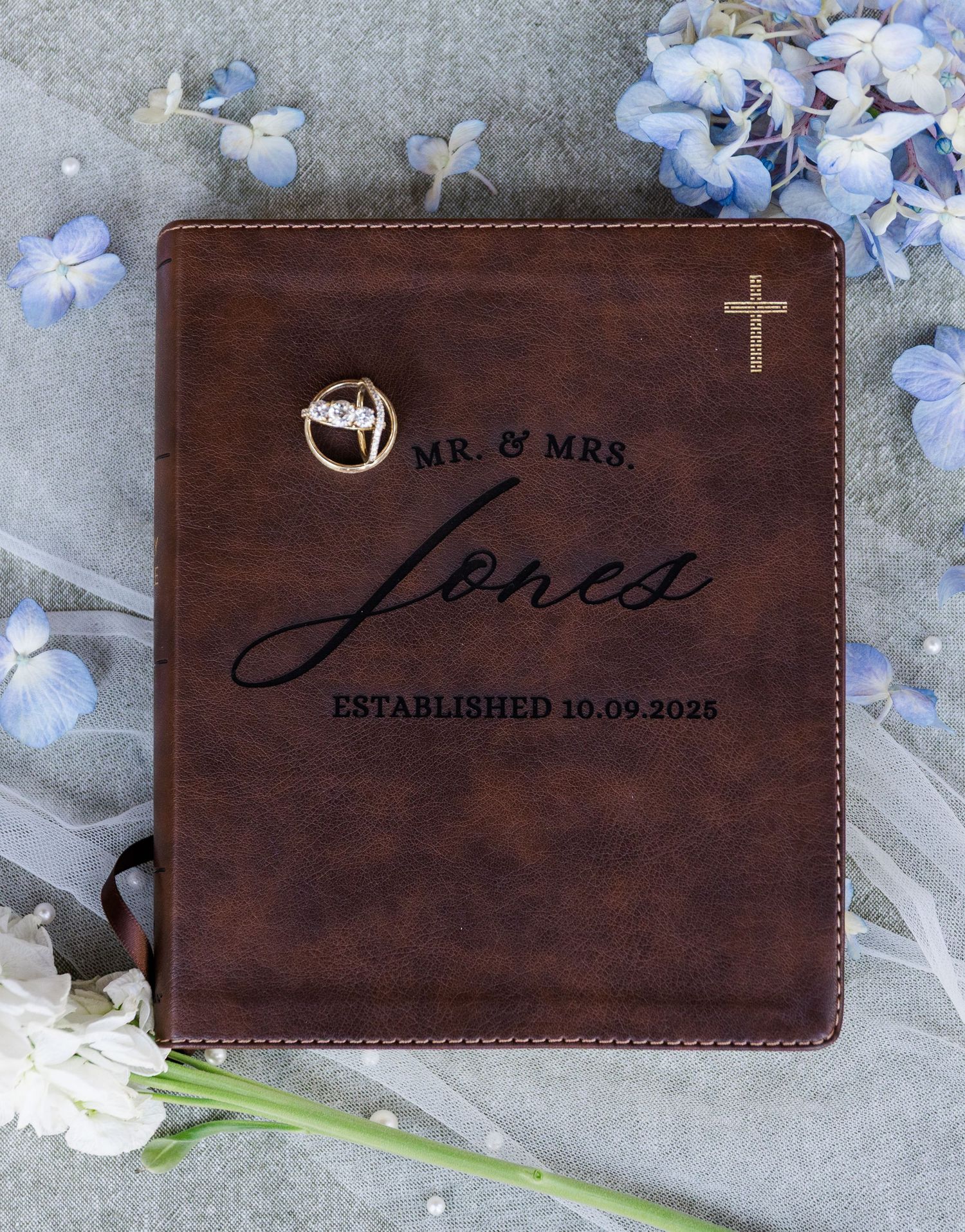 Personalized brown leather wedding Bible engraved with Mr. & Mrs. Jones established 10.09.2025 with a cross and diamond ring.