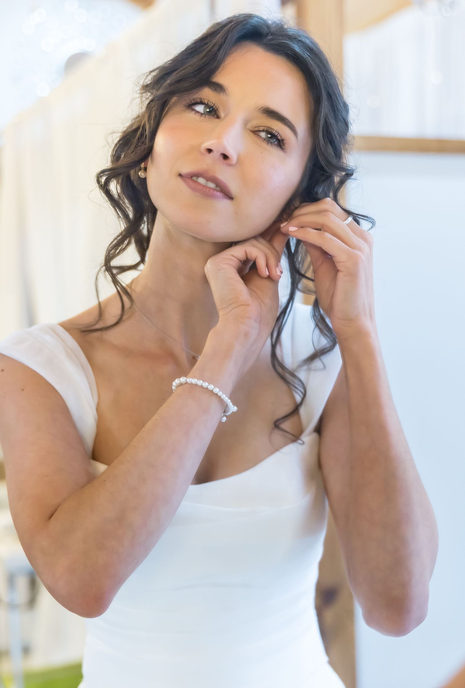 A series of four similar portrait shots showing a person with dark hair posing expressively against a bright background.
