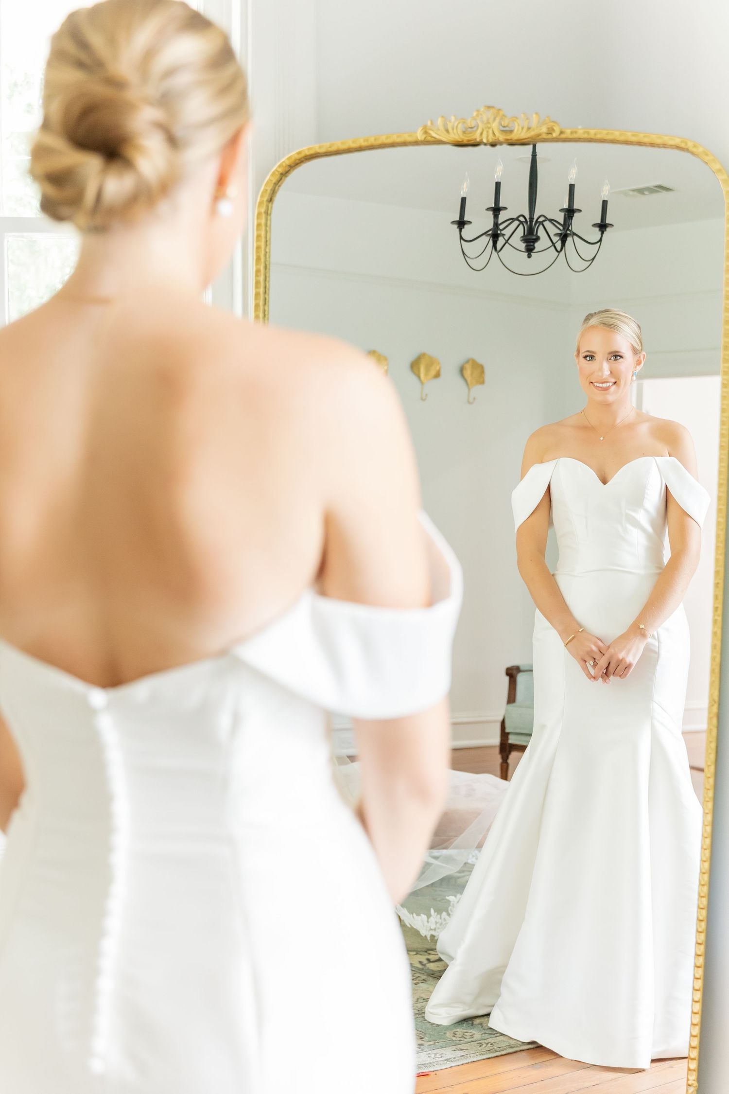 A series of white-themed bridal portraits showing a strapless wedding dress reflected in elegant gold-framed mirrors.