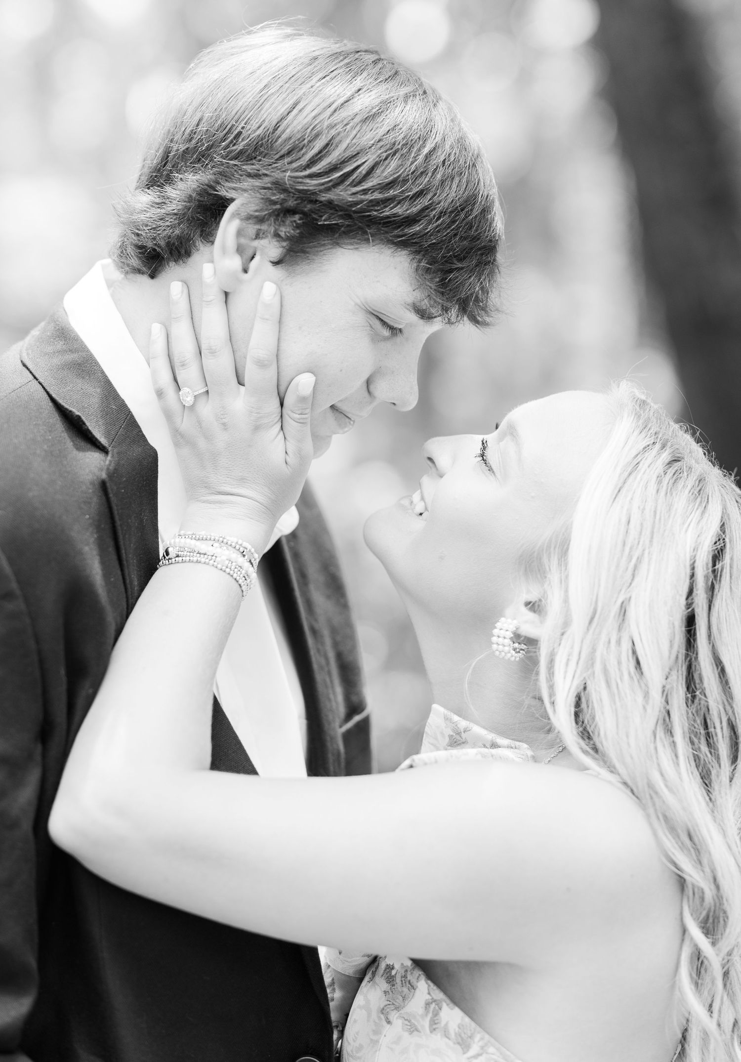 A romantic black and white portrait of a couple sharing an intimate moment during their wedding celebration.