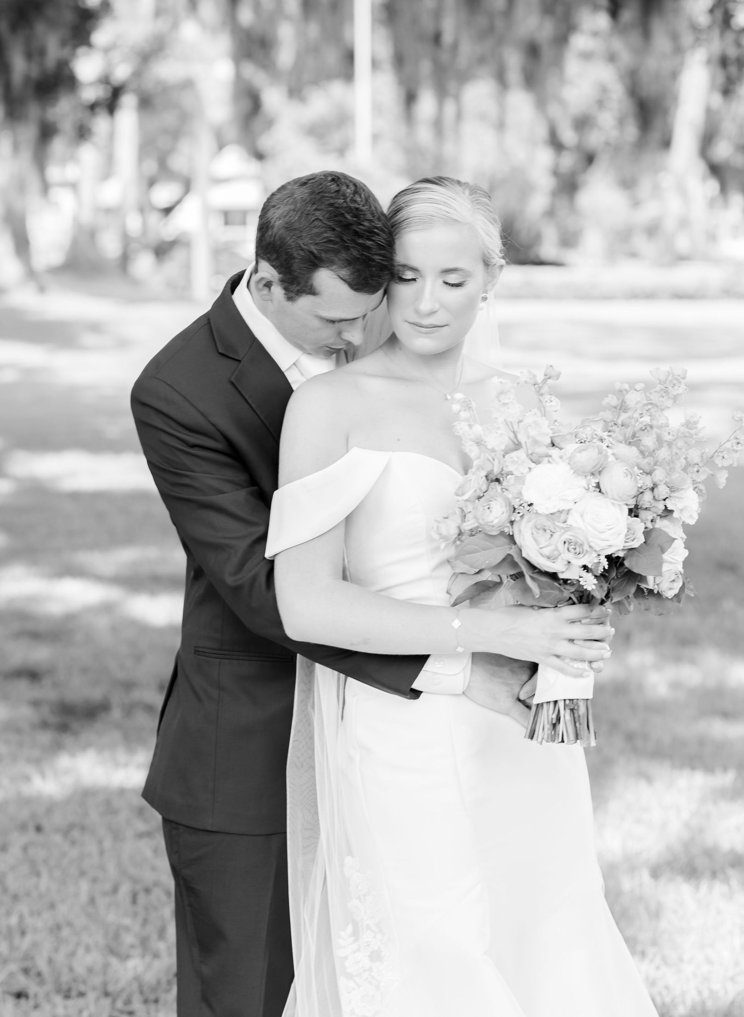 Black and white wedding photo series showing intimate moments between newlyweds in an outdoor garden setting.