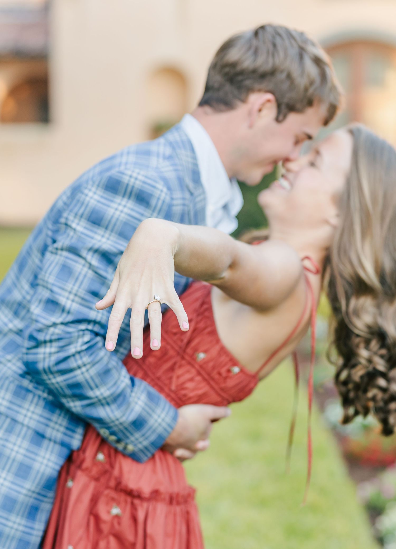 Couple sharing passionate moments in garden setting wearing coordinated casual outfits.