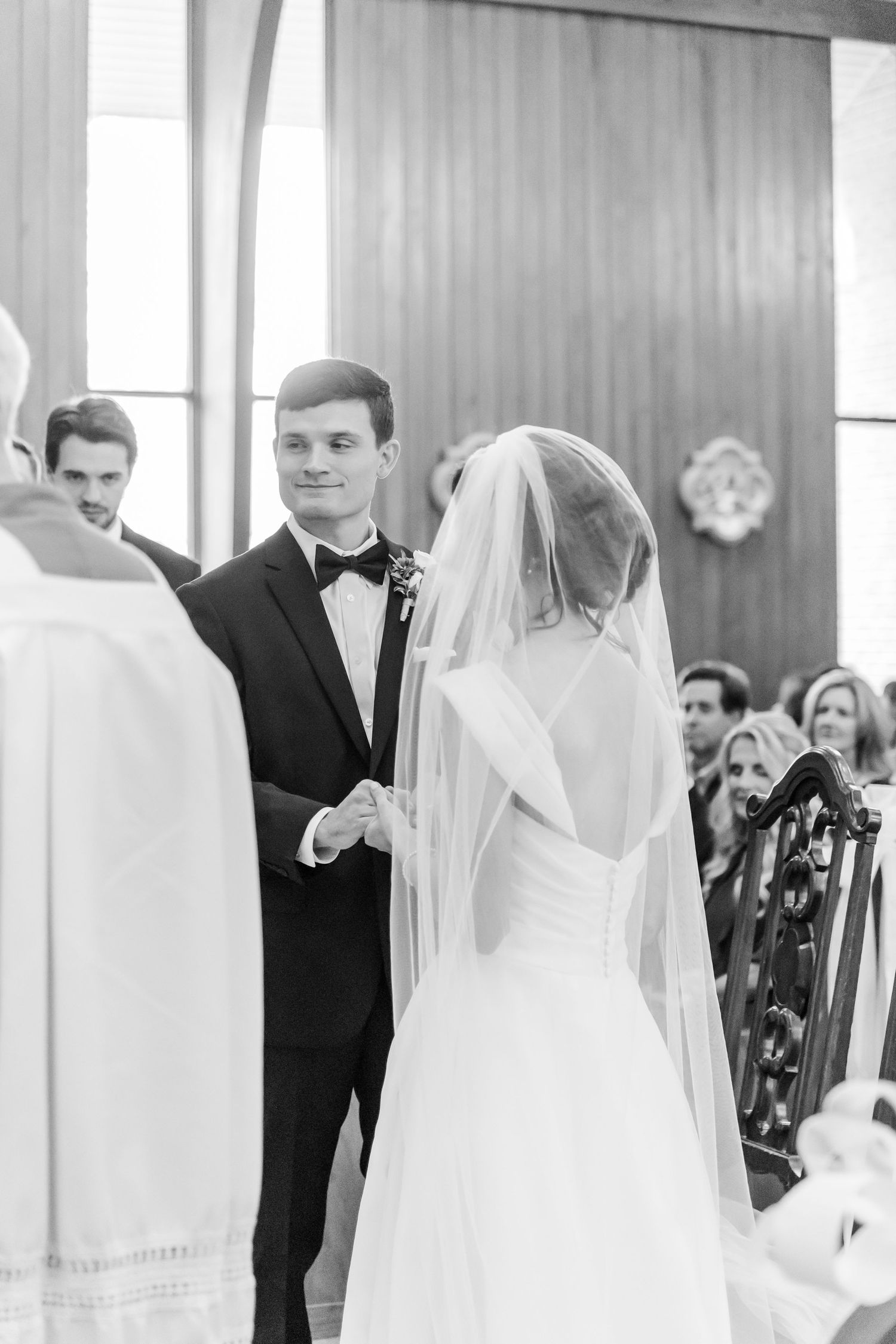 Traditional church wedding ceremony with flowing white veil and formal attire.