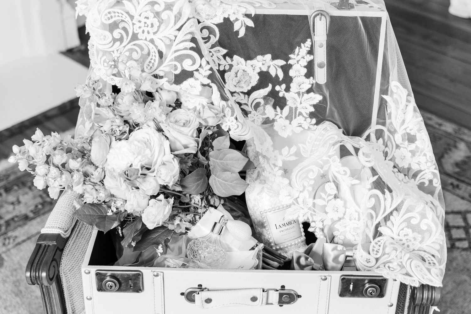 A black and white photo collage of wedding details including floral arrangements and table settings.
