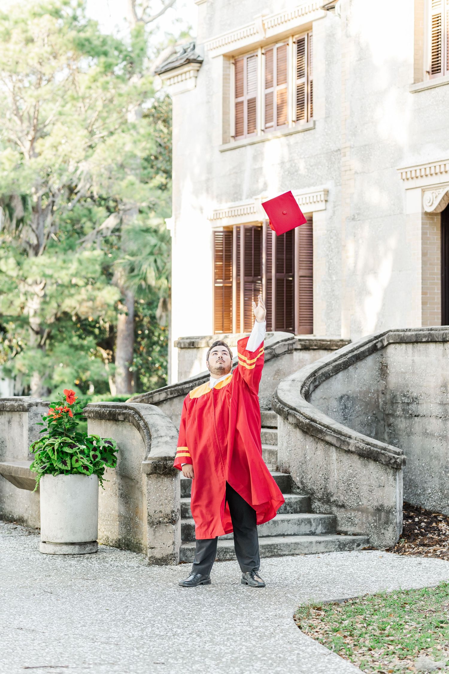 A sequence of three photos showing a person in red jumping with a red flag against a historic stone building.
