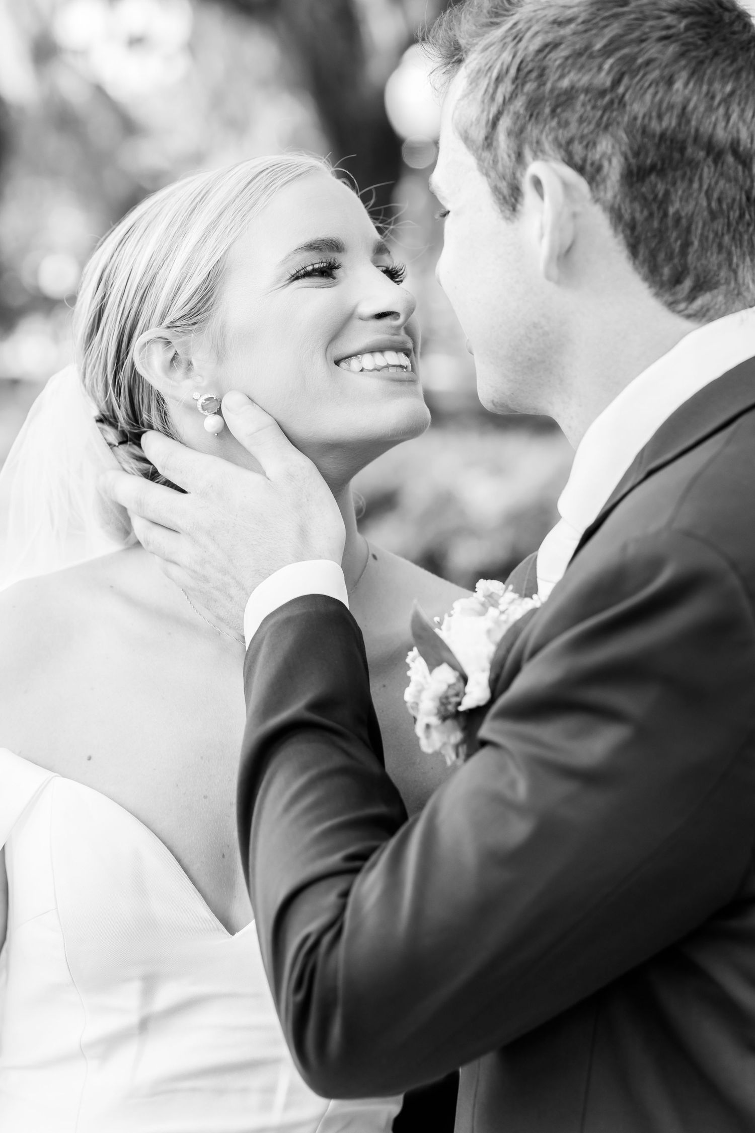 Black and white candid wedding portrait showing joy and emotion.
