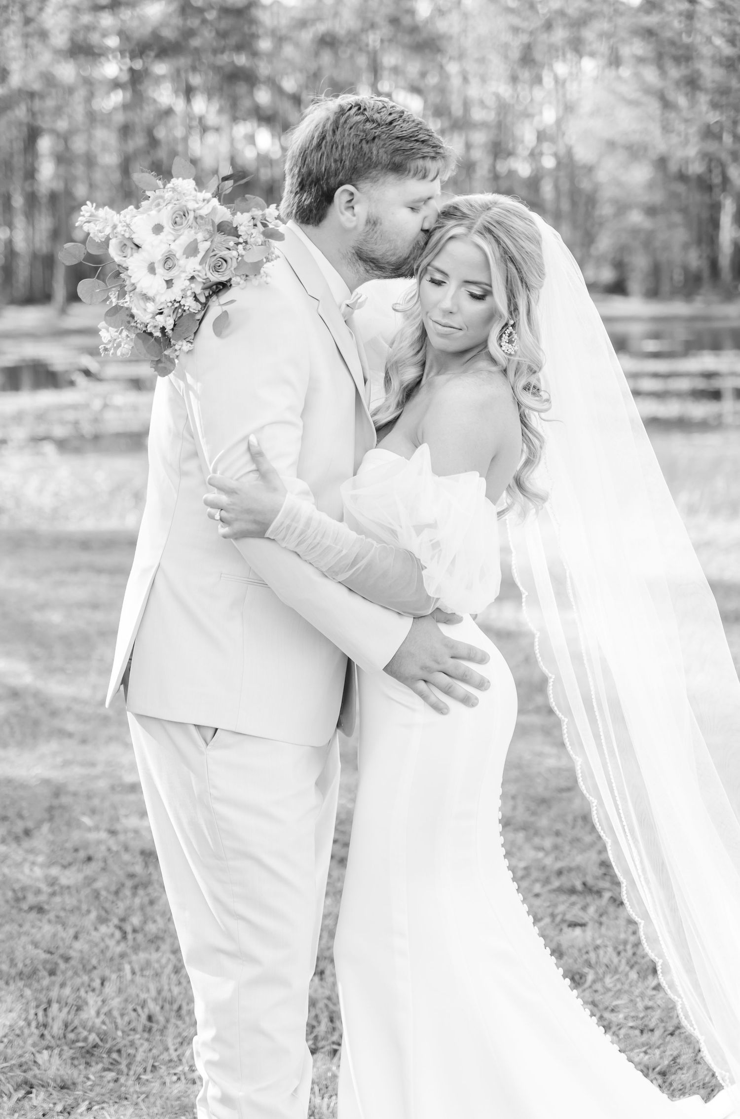 Black and white portrait of a tender wedding moment between bride and groom.