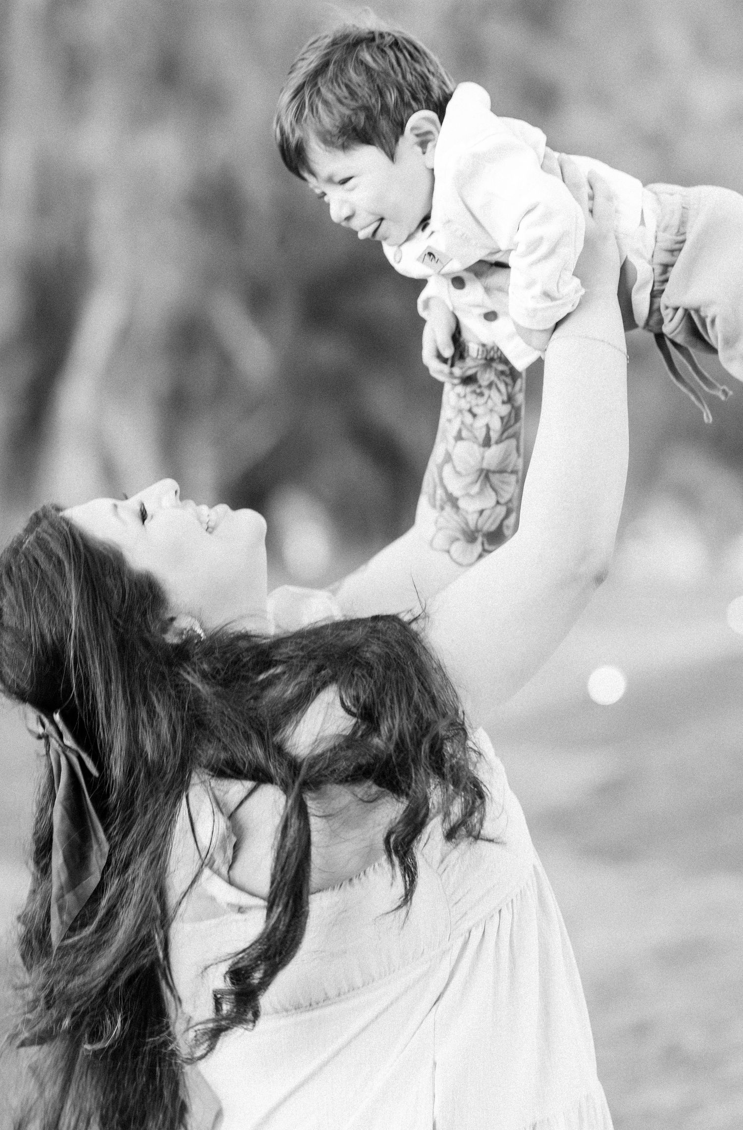 Black and white series capturing intimate parent-child moments with natural expressions and movement.