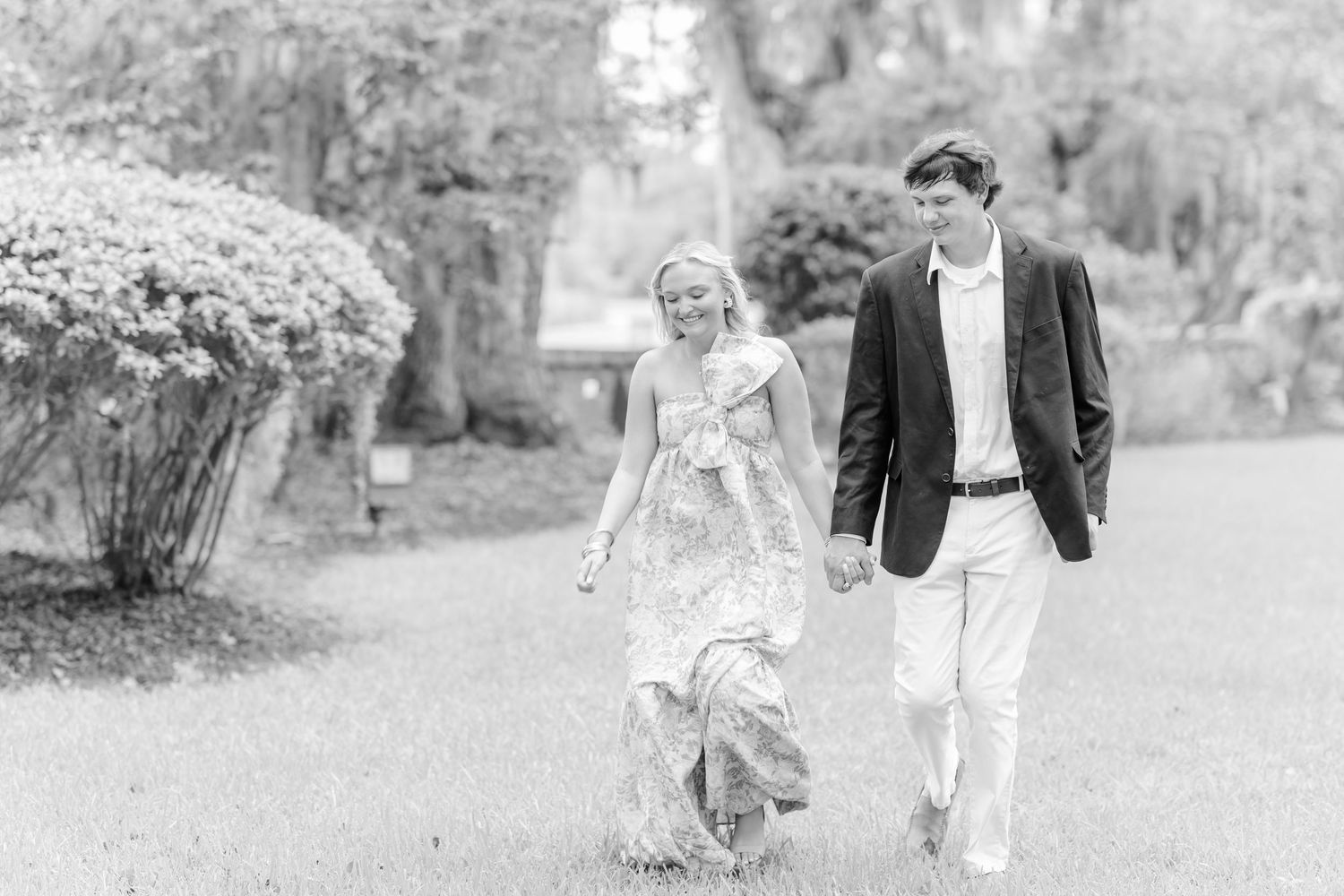 A series of black and white wedding photos showing joyful outdoor moments in a garden setting.
