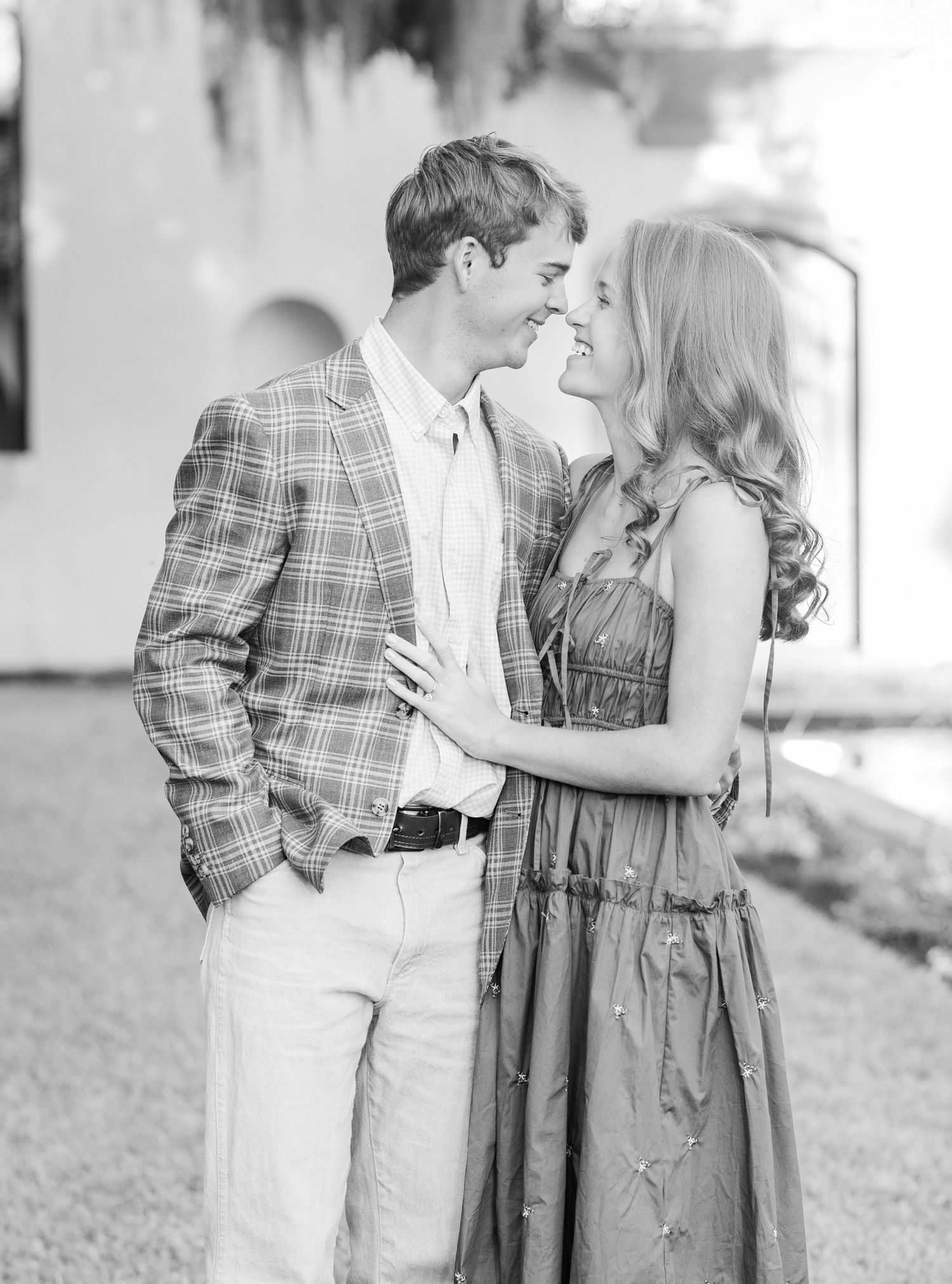 An intimate moment captured between two people in elegant attire.