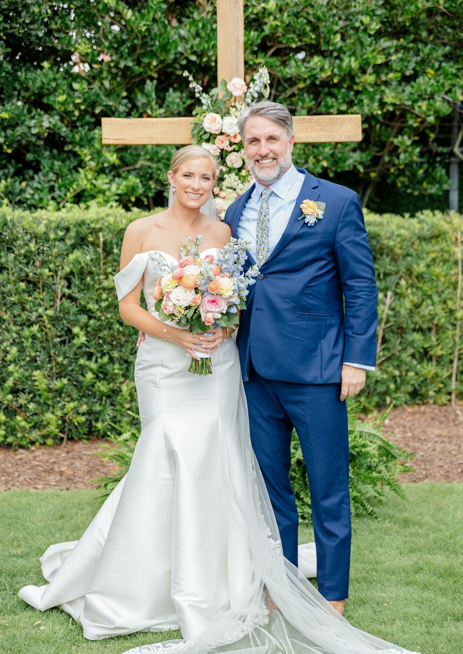A romantic outdoor wedding photo series showing a couple in formal attire surrounded by lush green gardens.
