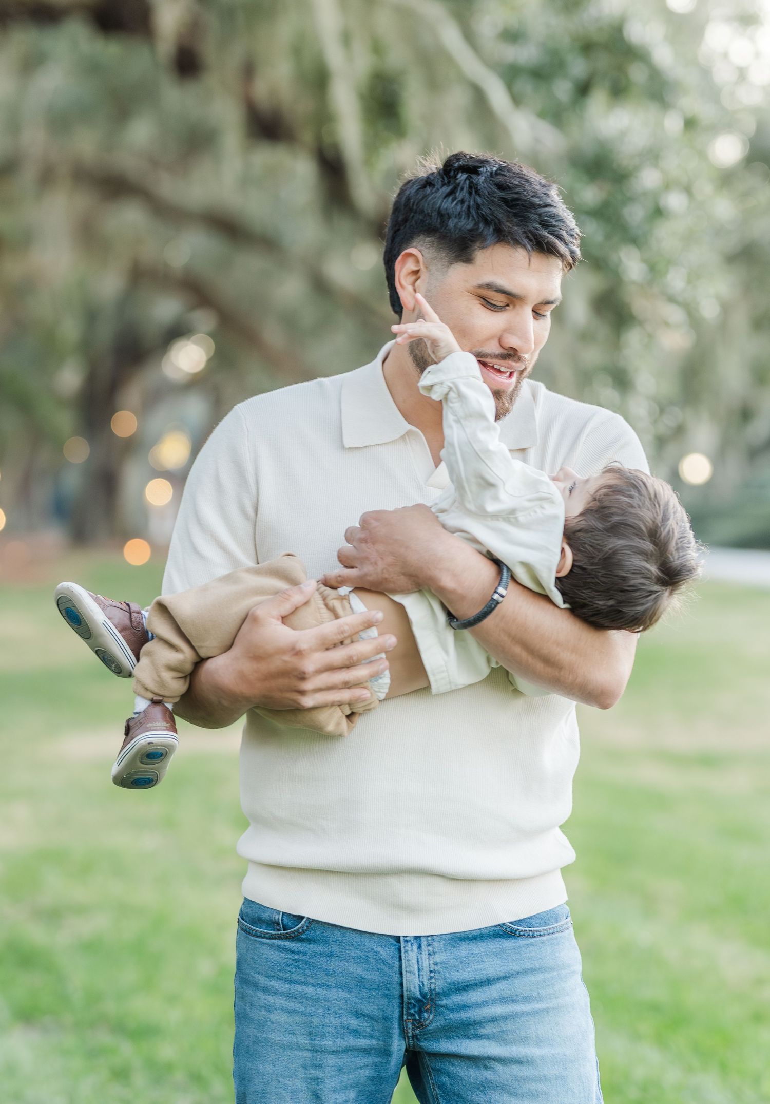 Playful family moments captured in a series of candid photos on grassy outdoor setting.