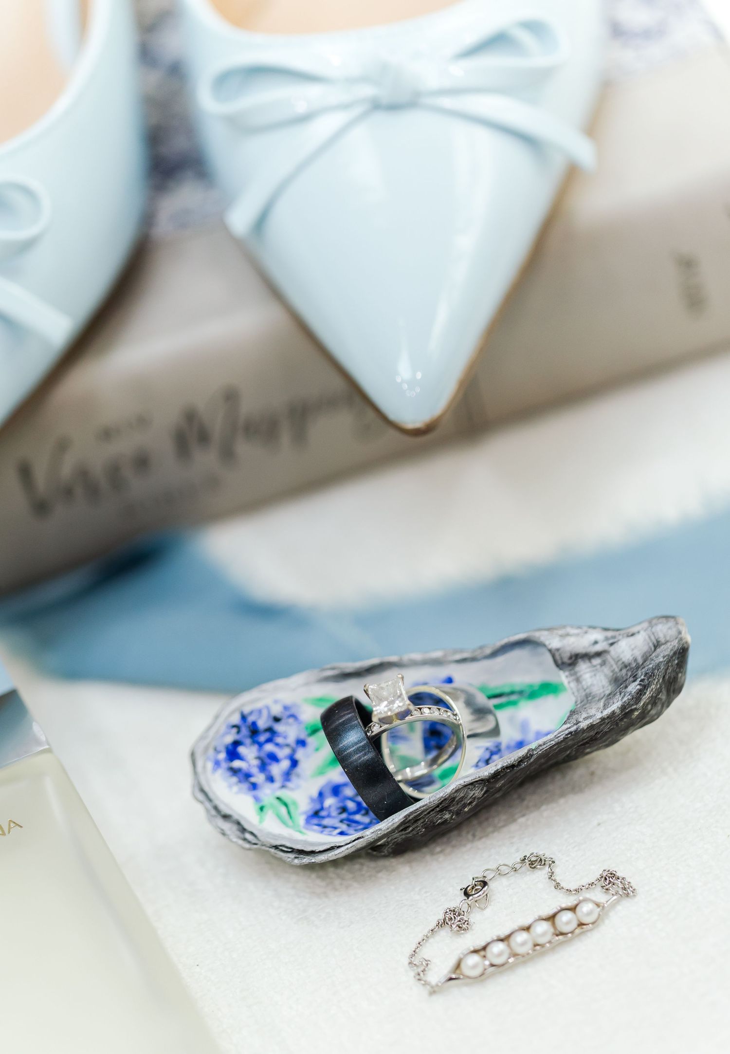 Close-up sequence showing crushed oyster shells being transformed into delicate pearl-like jewelry pieces.
