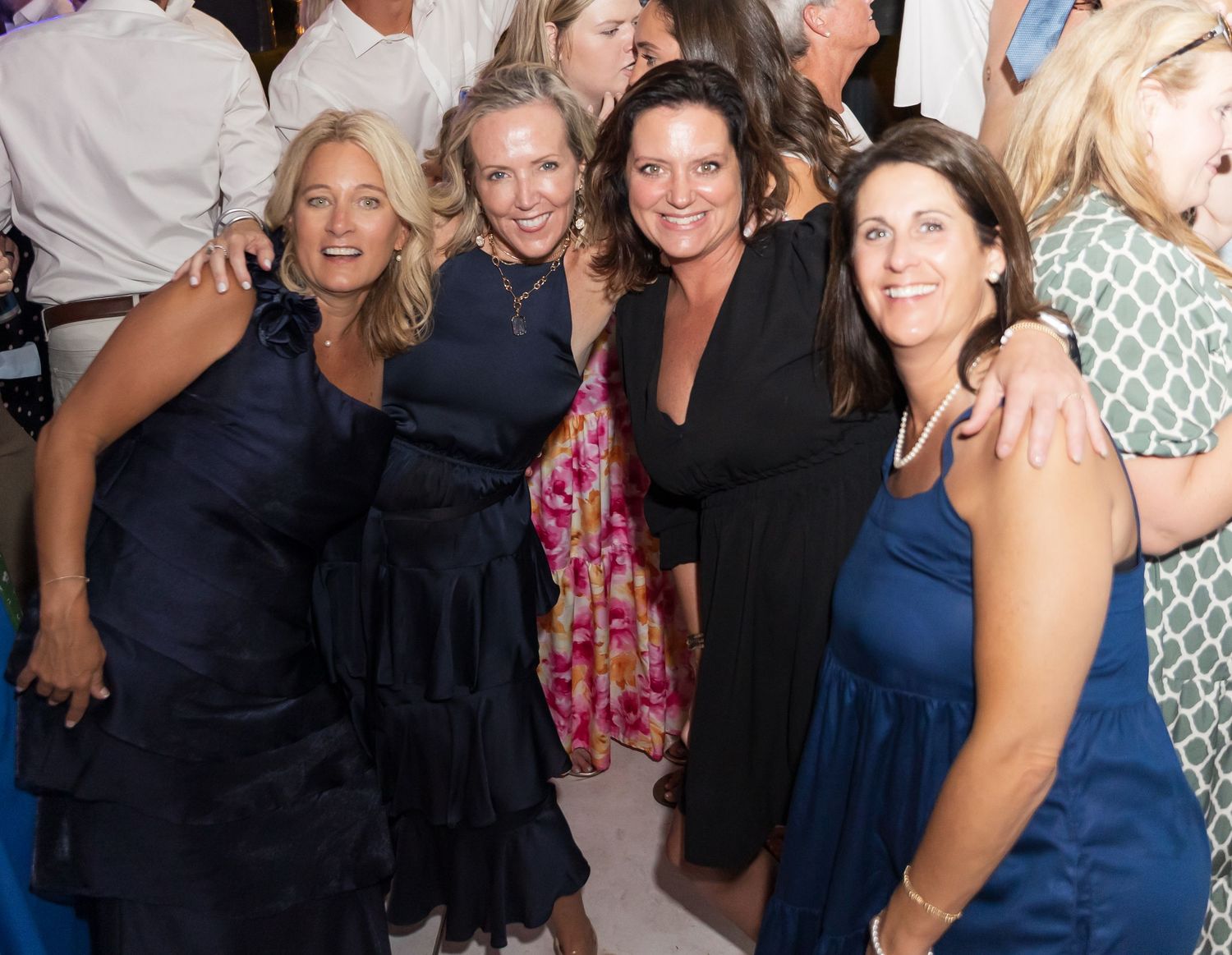 Large group of wedding guests gathered together for dancing and celebration.