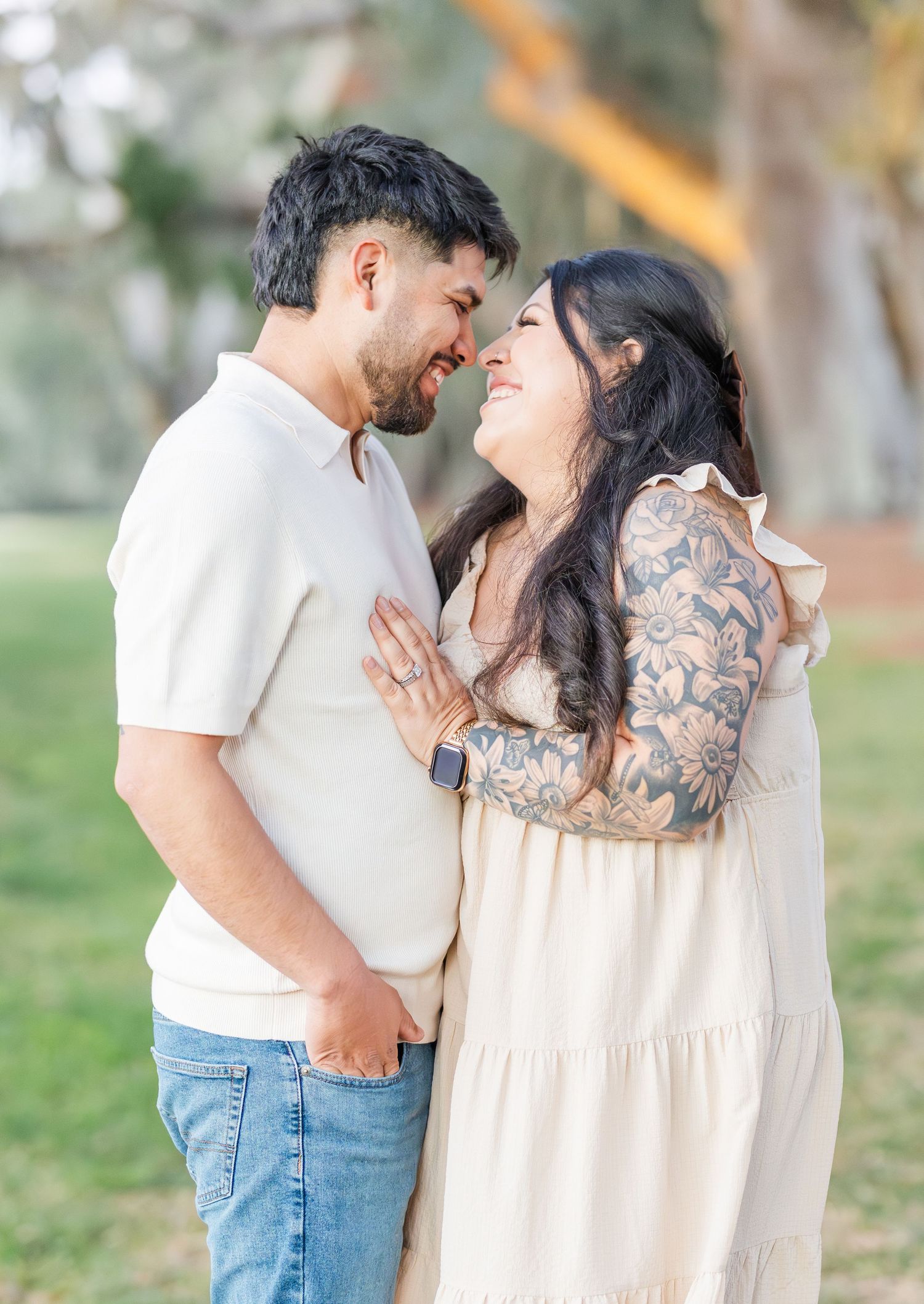 Intimate couple portrait showing affectionate moment in outdoor setting.