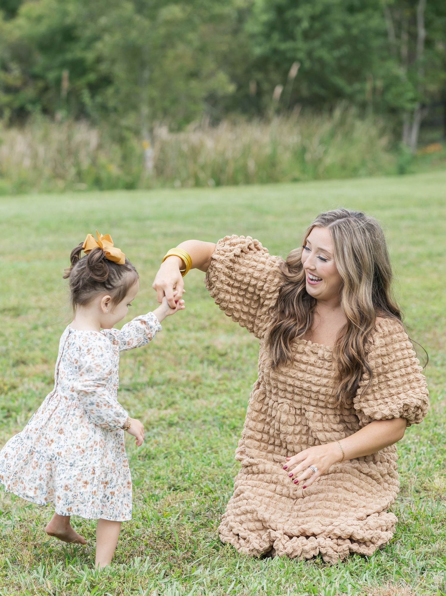 A heartwarming outdoor scene with people playing and laughing together on a grassy field.