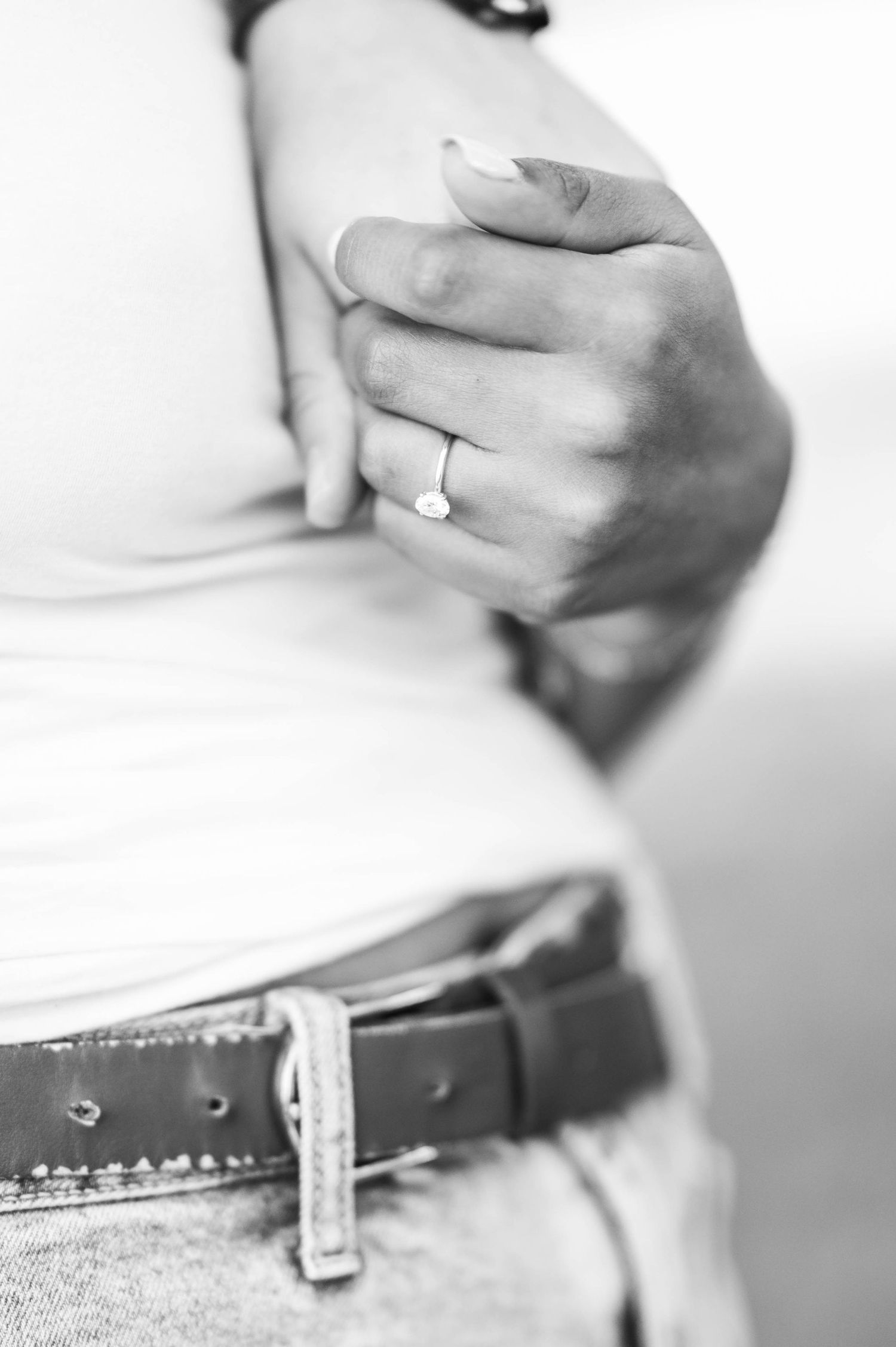 Close-up black and white detail shots of hands and belts.