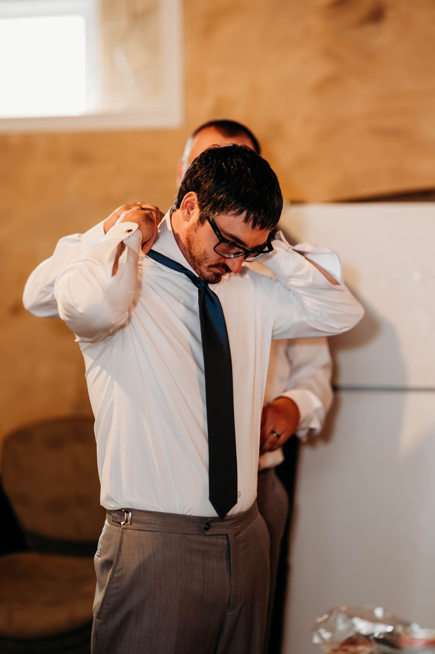 A sequence of images showing someone in a white shirt and tie dabbing in various poses.