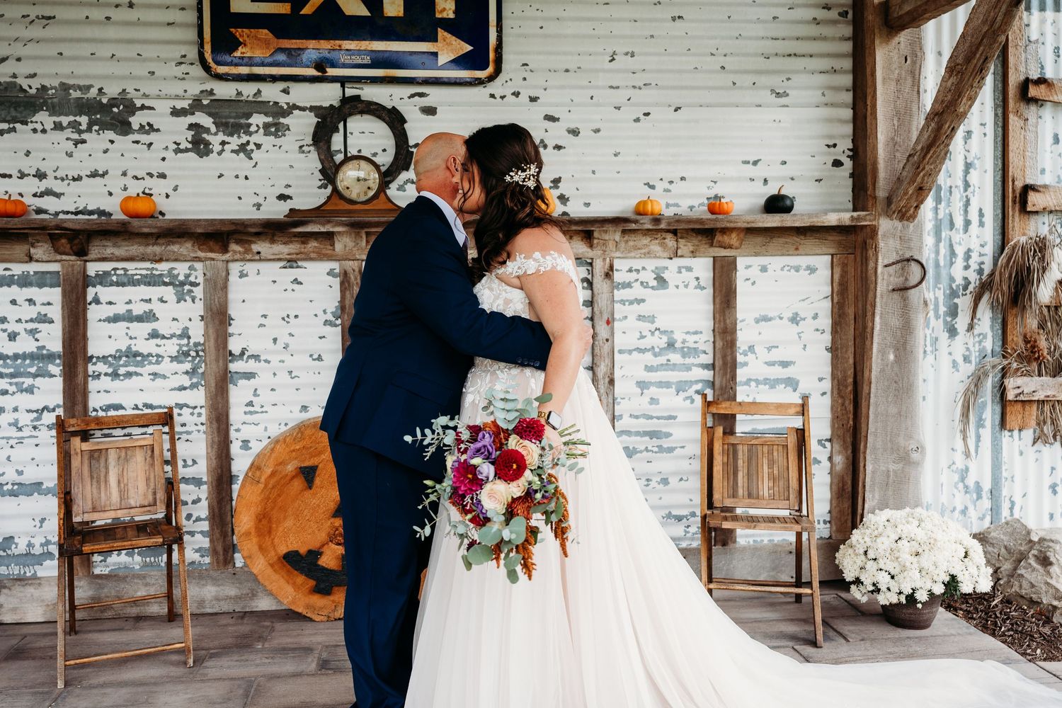 A romantic wedding photoshoot in a rustic barn venue with exposed brick walls and wooden beams.