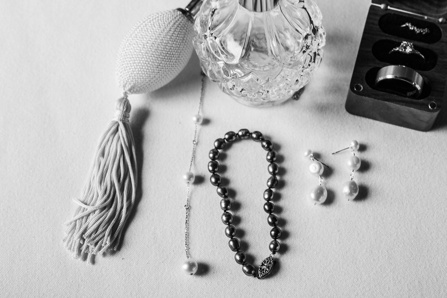 Black and white jewelry collection featuring beaded bracelets, necklaces and accessories arranged on a white surface.