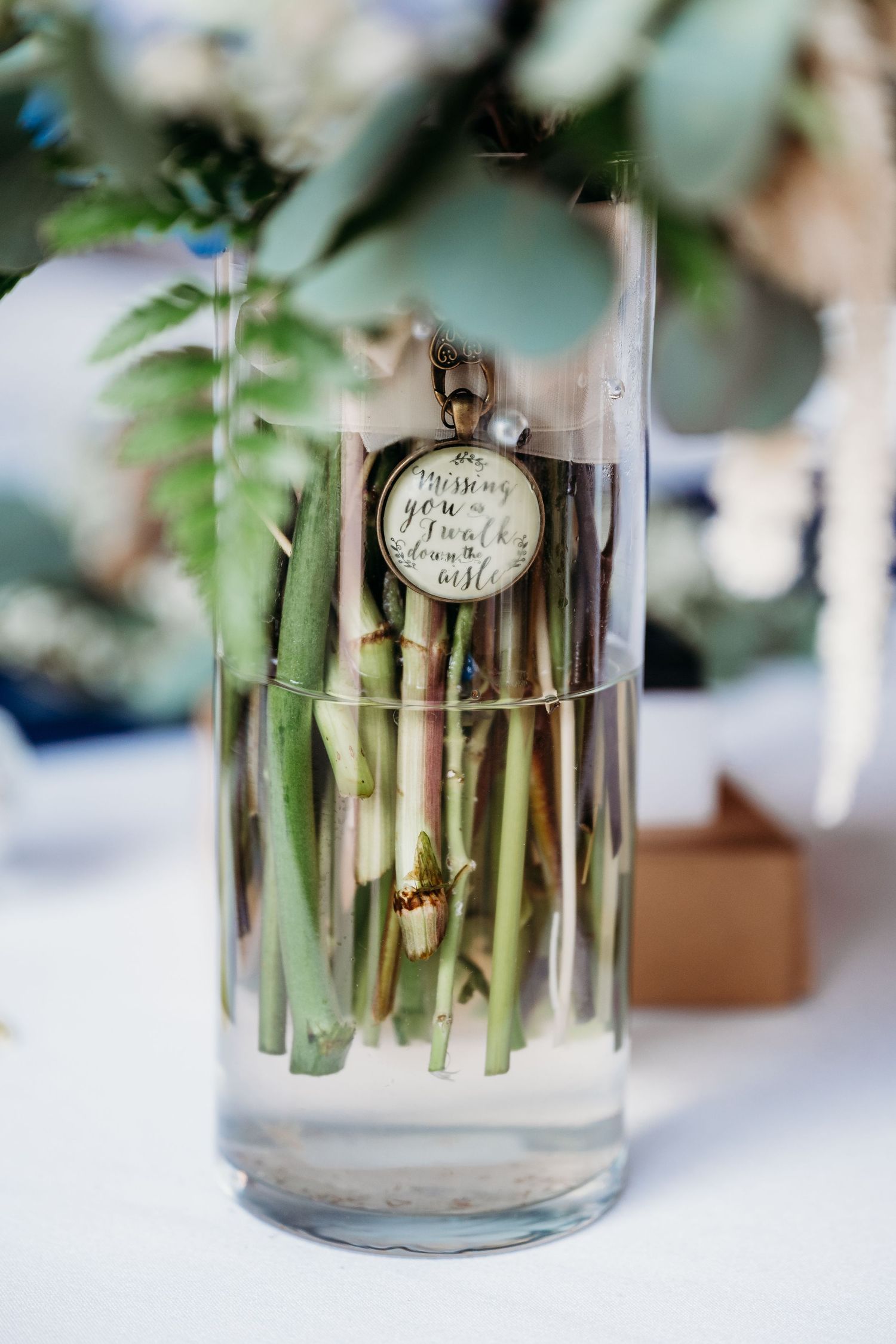 Fresh green asparagus spears displayed in glass containers with decorative labels for an elegant table setting.