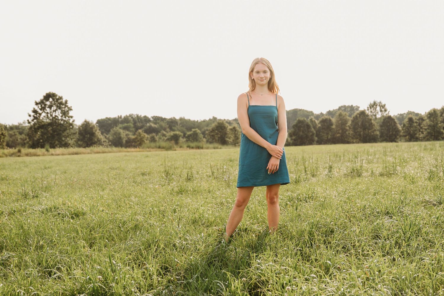 Series of outdoor portraits captured in a sun-lit meadow with tall grass and natural scenery.