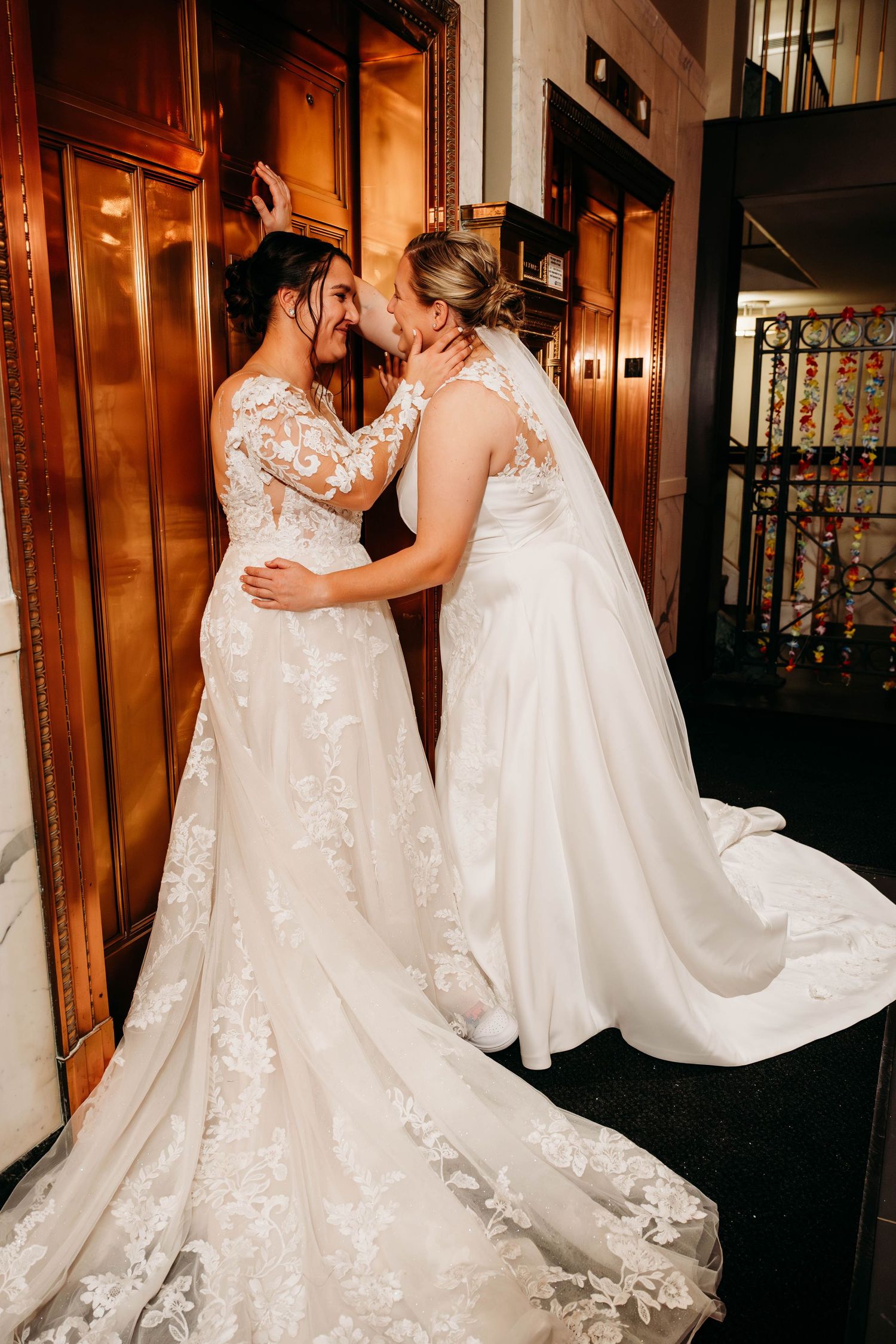 Wedding couples sharing intimate moments in elegant white gowns against wooden paneled walls.