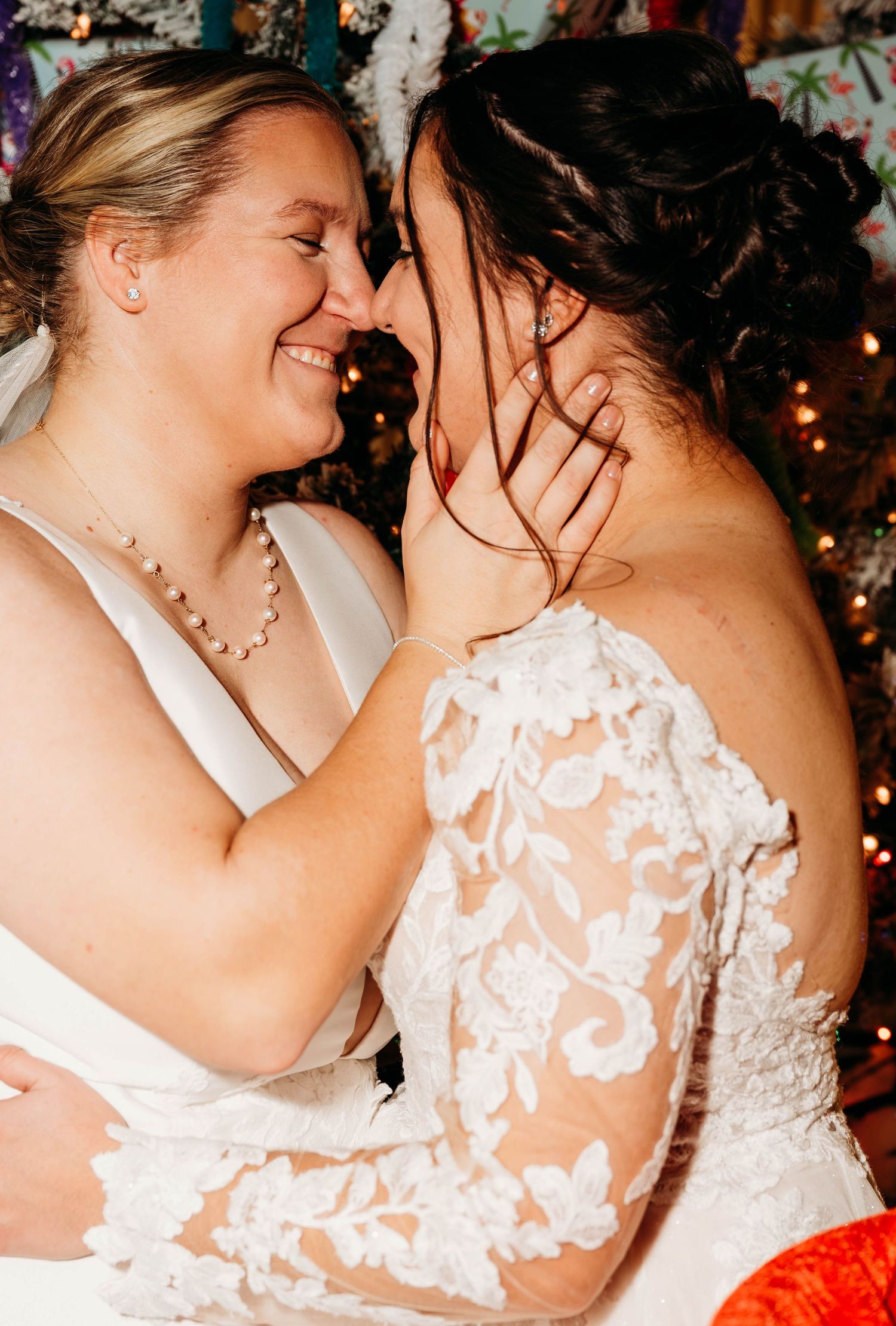 A tender romantic moment between two people in wedding attire sharing an intimate embrace at a celebration.