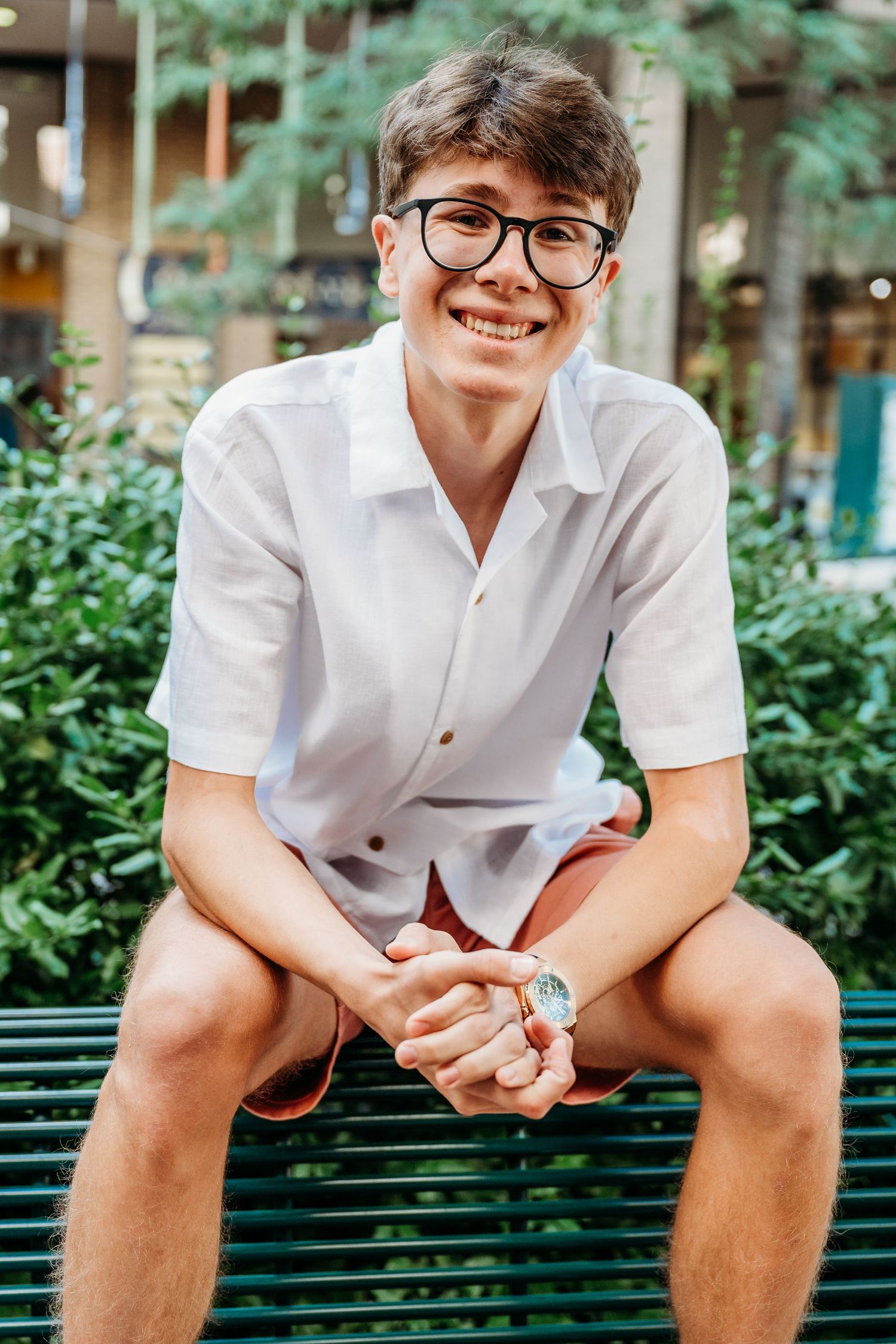 Three photos of someone in a white shirt sitting on a bench with greenery in the background.