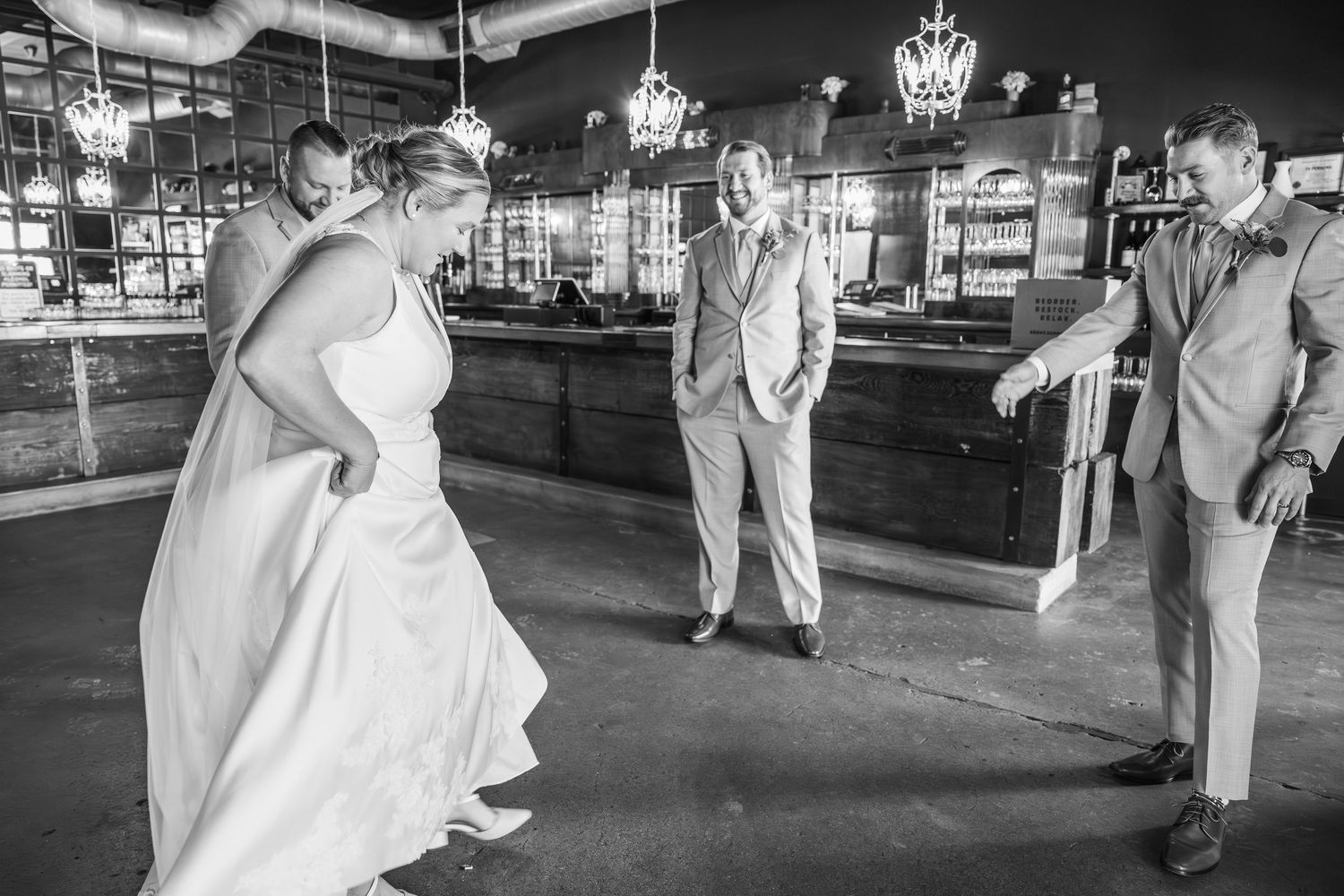 Dancing couple in formal attire share an intimate moment on an outdoor dance floor at night.