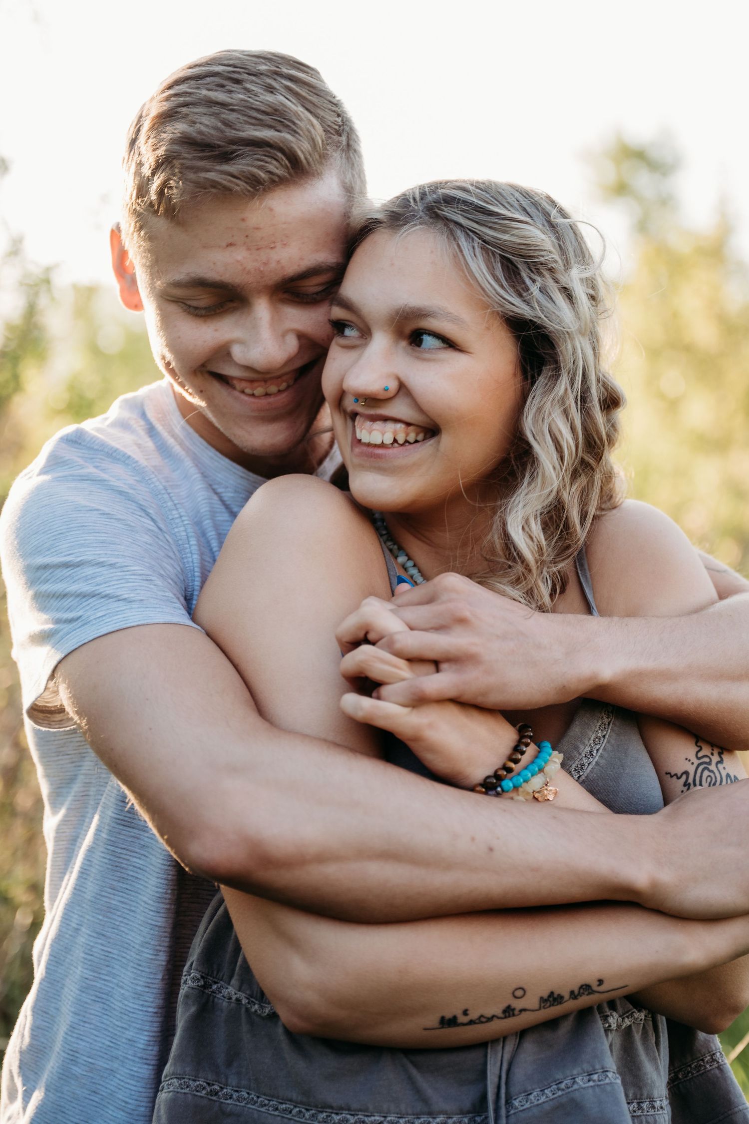 A tender moment between a couple embracing lovingly in golden outdoor light, shown in three candid poses.