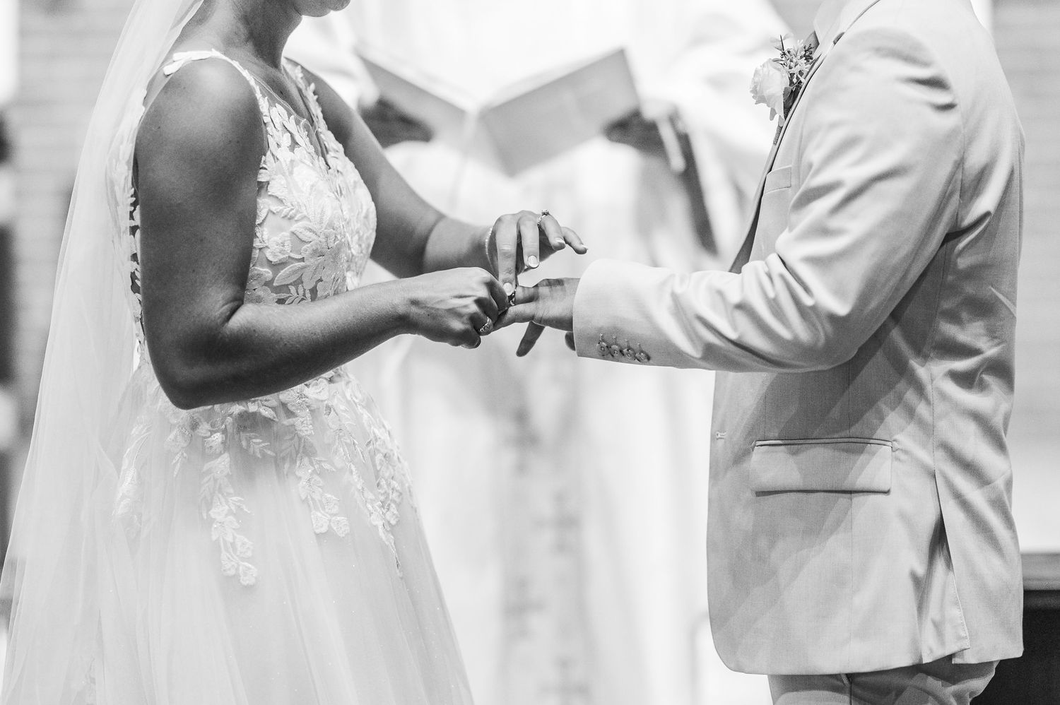 Black and white wedding photos showing intimate moments between newlyweds during their ceremony and reception.