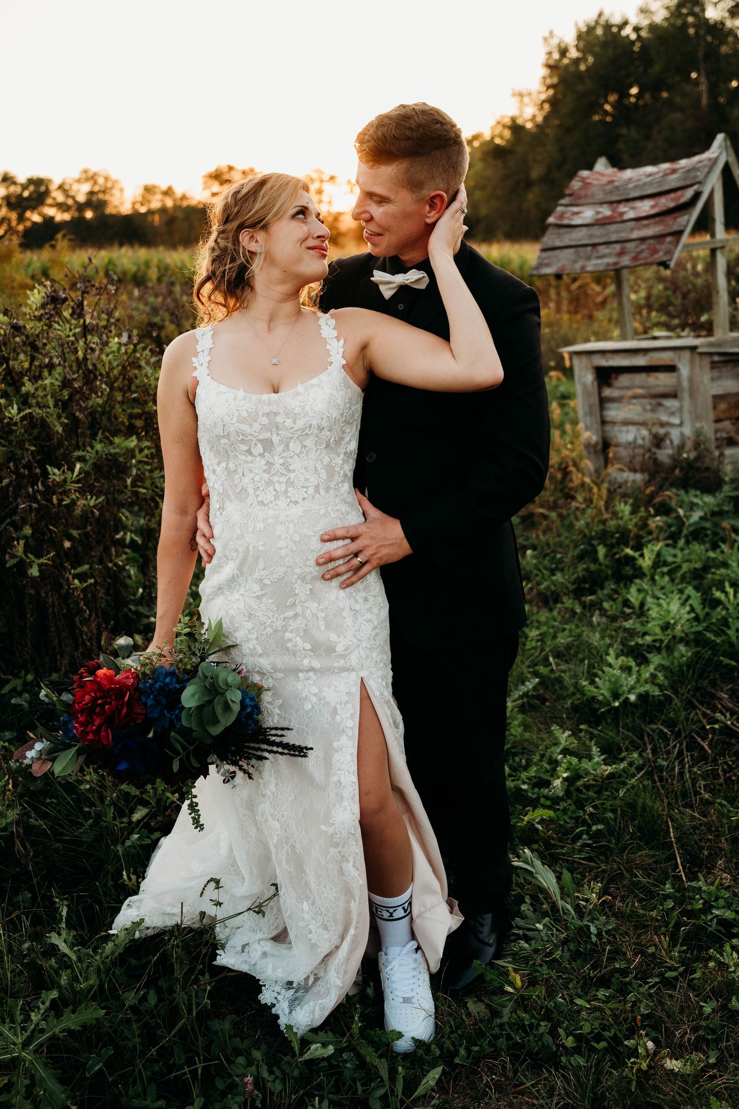 Romantic sunset wedding photos in a garden setting with bride wearing cowboy boots under her white gown.