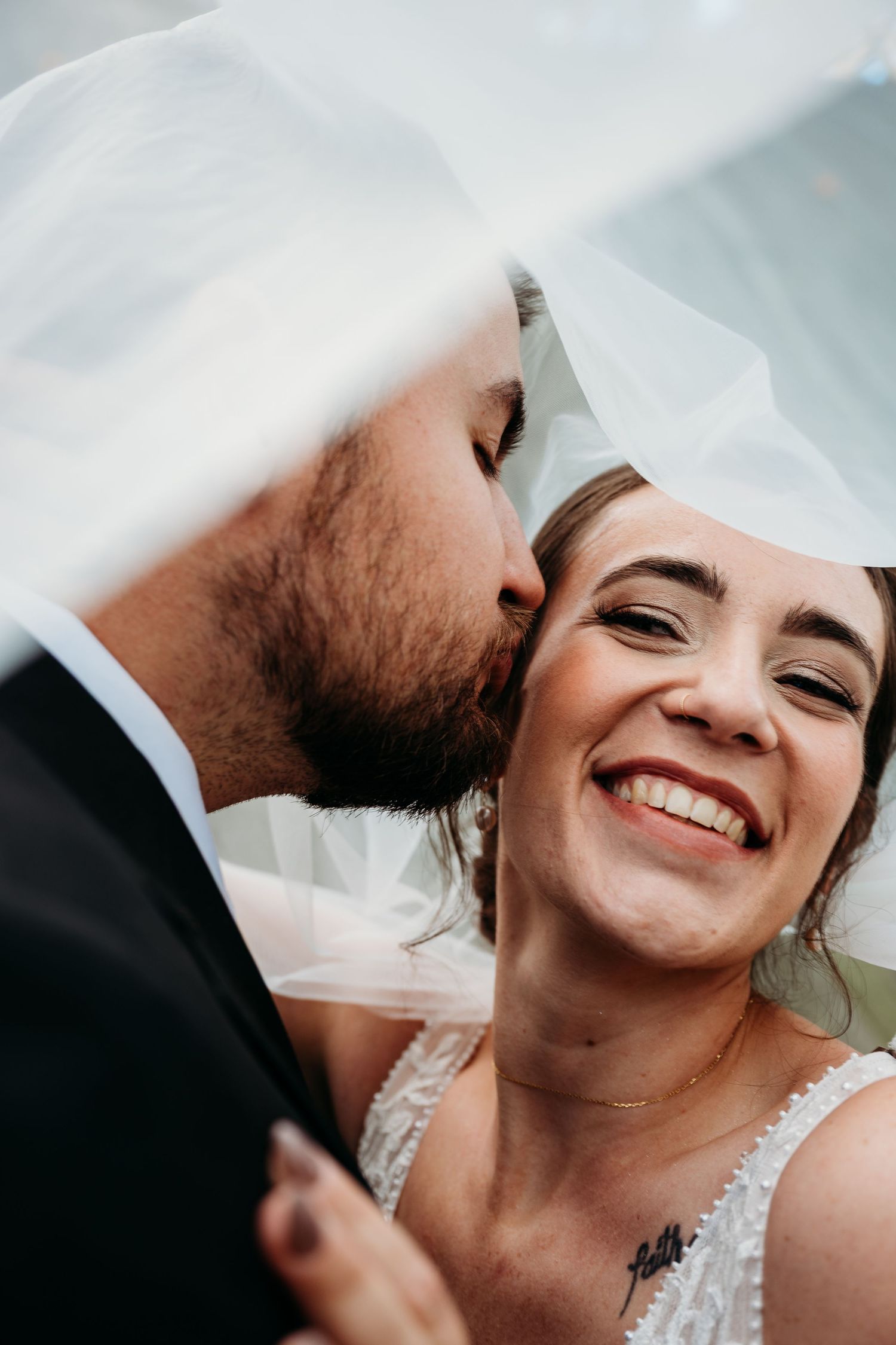 A series of intimate wedding photos showing tender moments and joyful expressions between a couple in traditional attire.