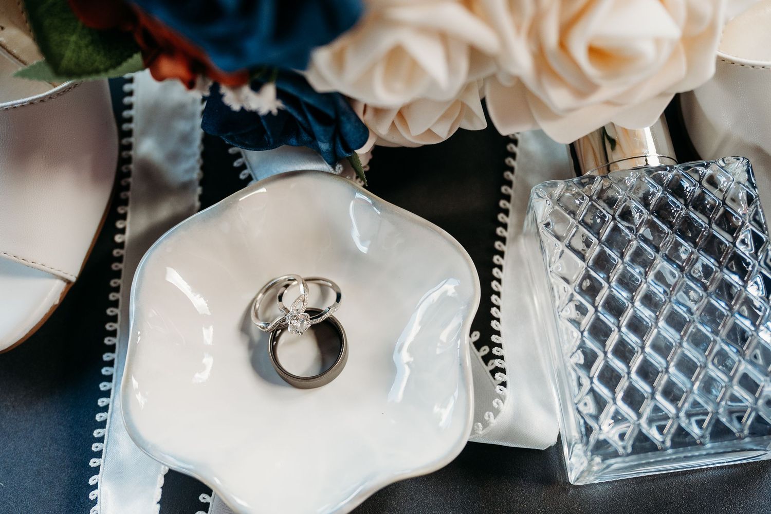 Close-up view of a professional cake decorating process showing piped white frosting details and texture work.