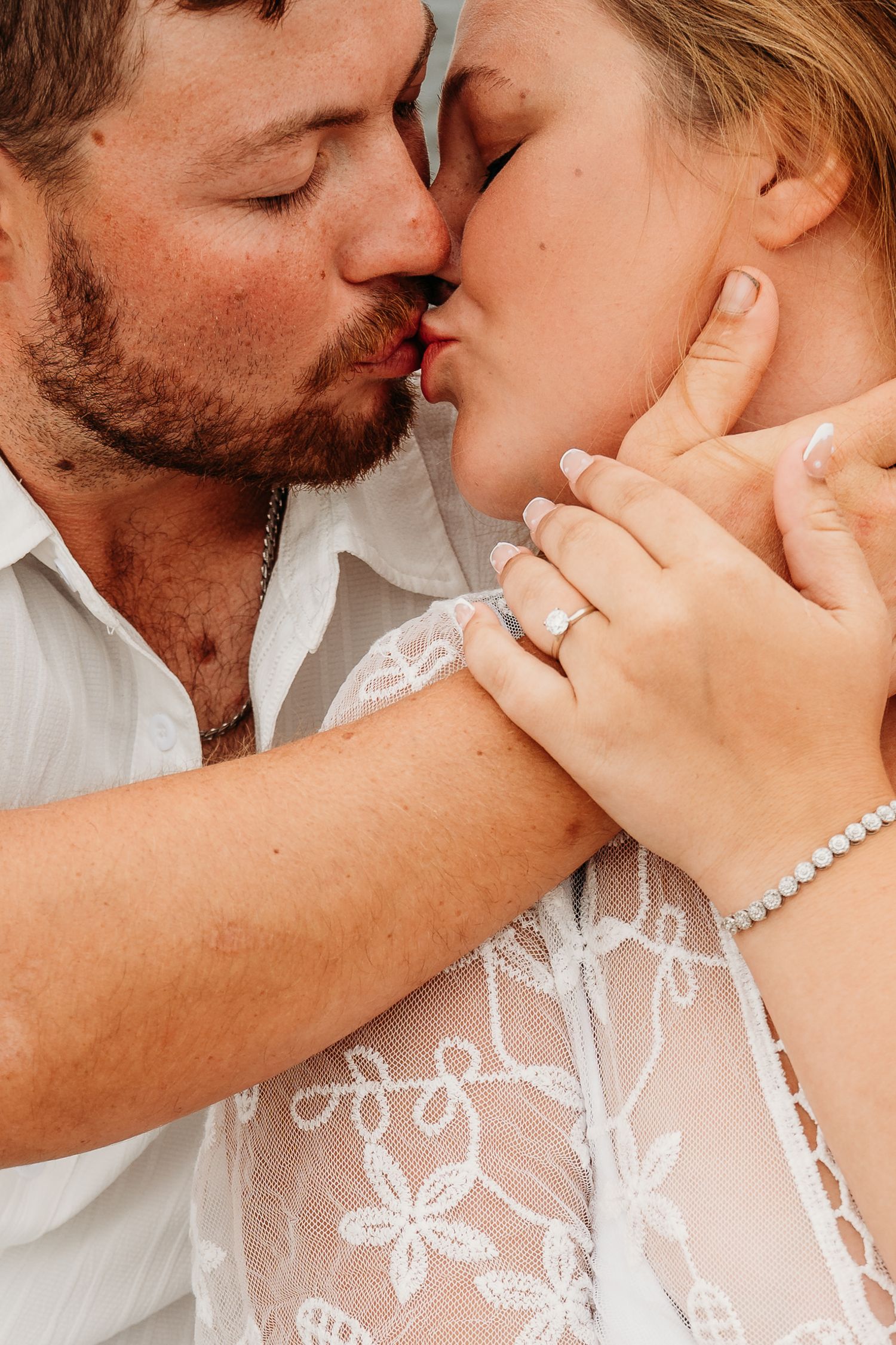 A romantic sequence of close-up shots showing a tender kiss moment with delicate lace details visible.